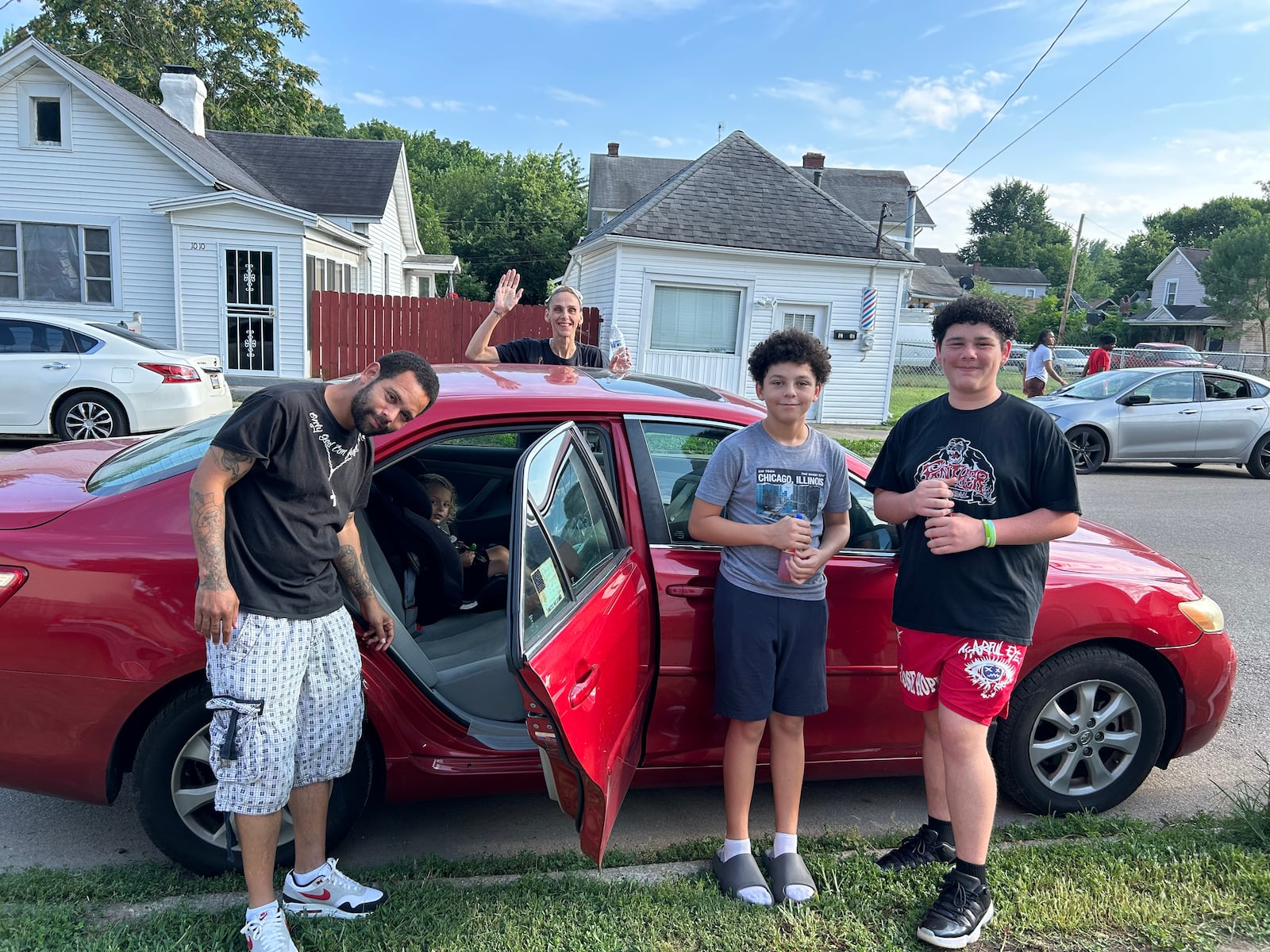 Brandon Wallace, Edie Philbeck and their boys in front of their Toyota Corolla, which they received this year. The car has over 200,000 miles on it and was donated to them by a friend of a friend. (Photo courtesy of Edie Philbeck)