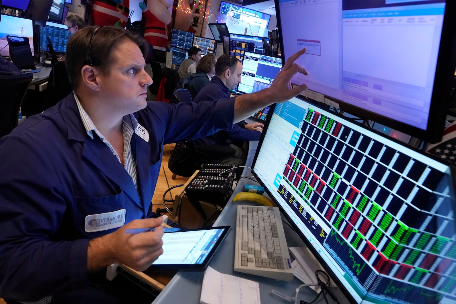 Trader Michael Milano works on the floor of the New York Stock Exchange, Wednesday, Dec. 18, 2024. (AP Photo/Richard Drew)