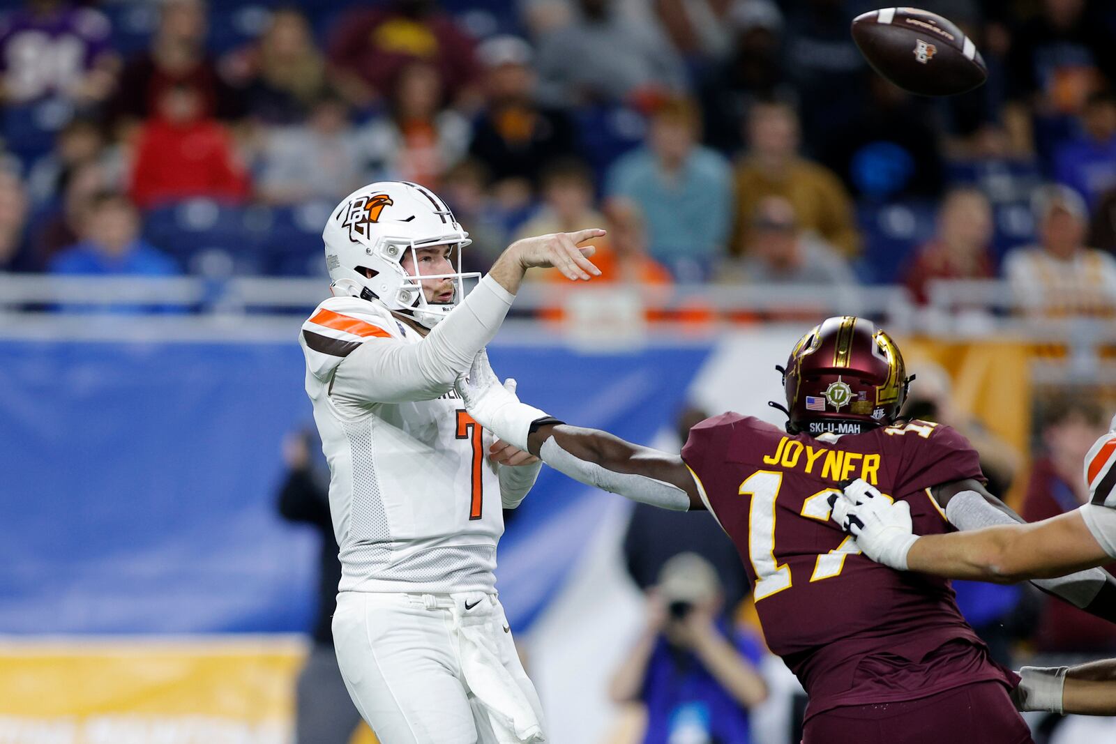 Bowling Green quarterback Connor Bazelak (7), left, throws a short pass against Minnesota defensive lineman Jah Joyner (17) during the first half of the Quick Lane Bowl NCAA college football game, Tuesday, Dec. 26, 2023, in Detroit. (AP Photo/Al Goldis)