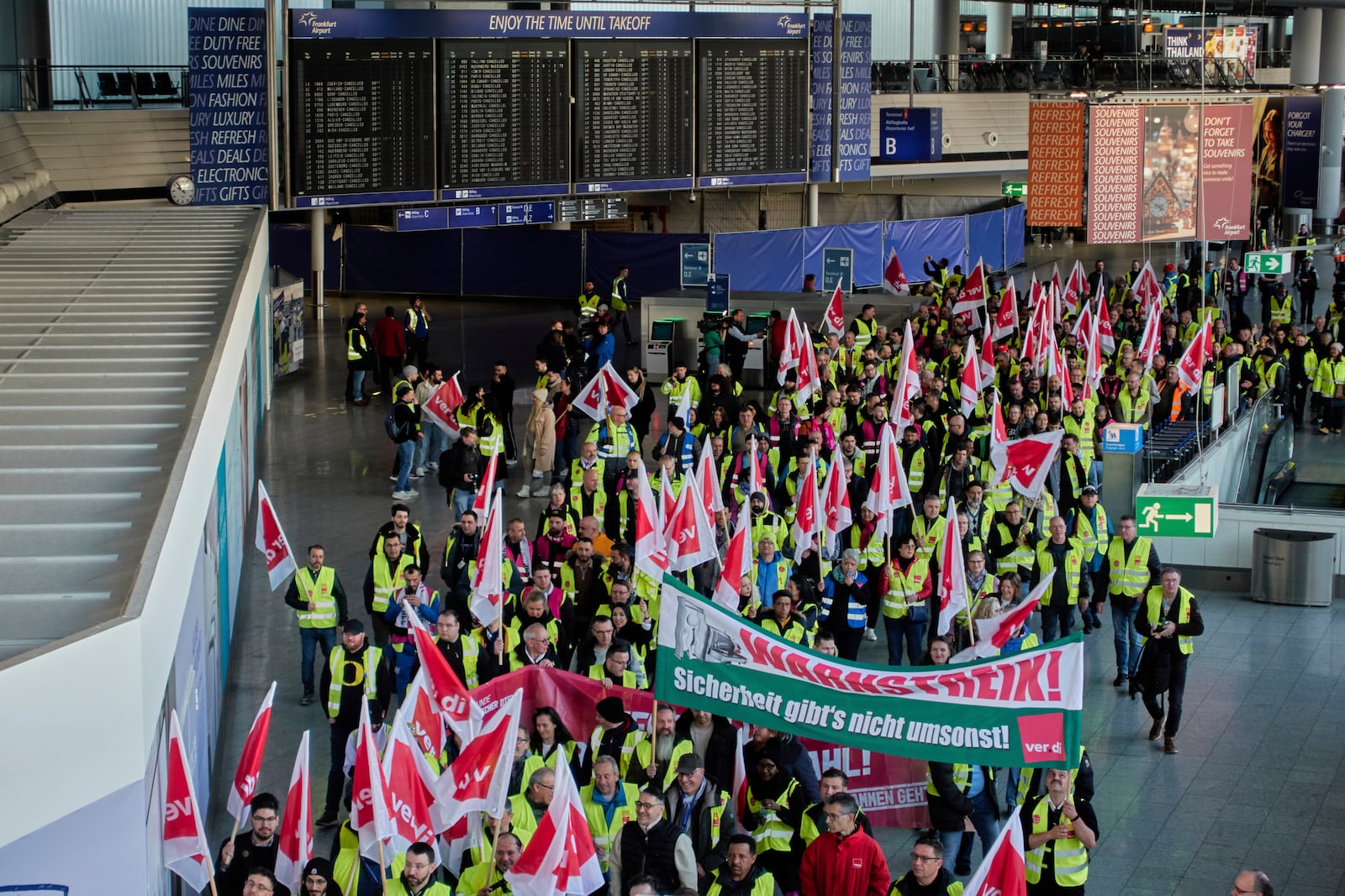 Airport employees organised in the Ver.di union walk through the airport in Frankfurt, Germany, Monday, March 10, 2025, when all major airports in Germany went on a warning strike. (AP Photo/Michael Probst)