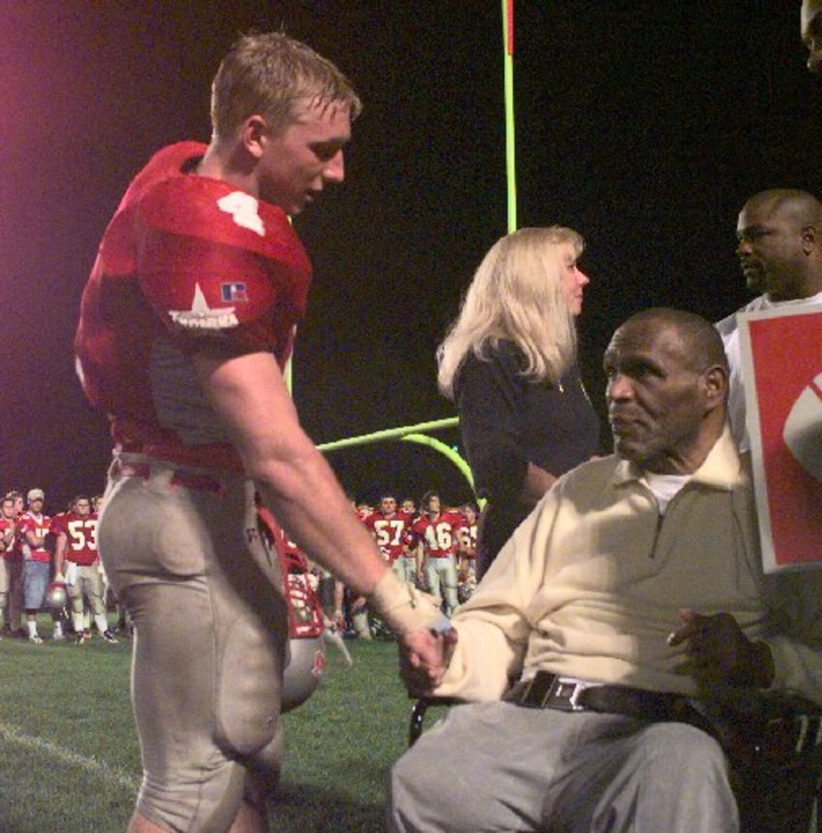 Troy's Ryan Brewer presents a game ball to Bob Ferguson and shakes his hand after breaking his Troy rushing record on 9/18/98 (one that has stood since 1958.) in a game vs. Centerville. JIM WITMER