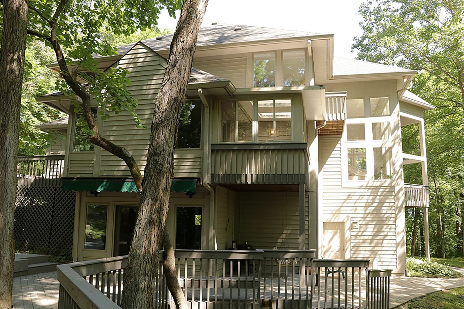 Paver bricks create a walkway around the house to a side patio, covered porch and multiple decks and wooden walkways that wrap around mature trees and lead to a gazebo. CONTRIBUTED PHOTO BY KATHY TYLER