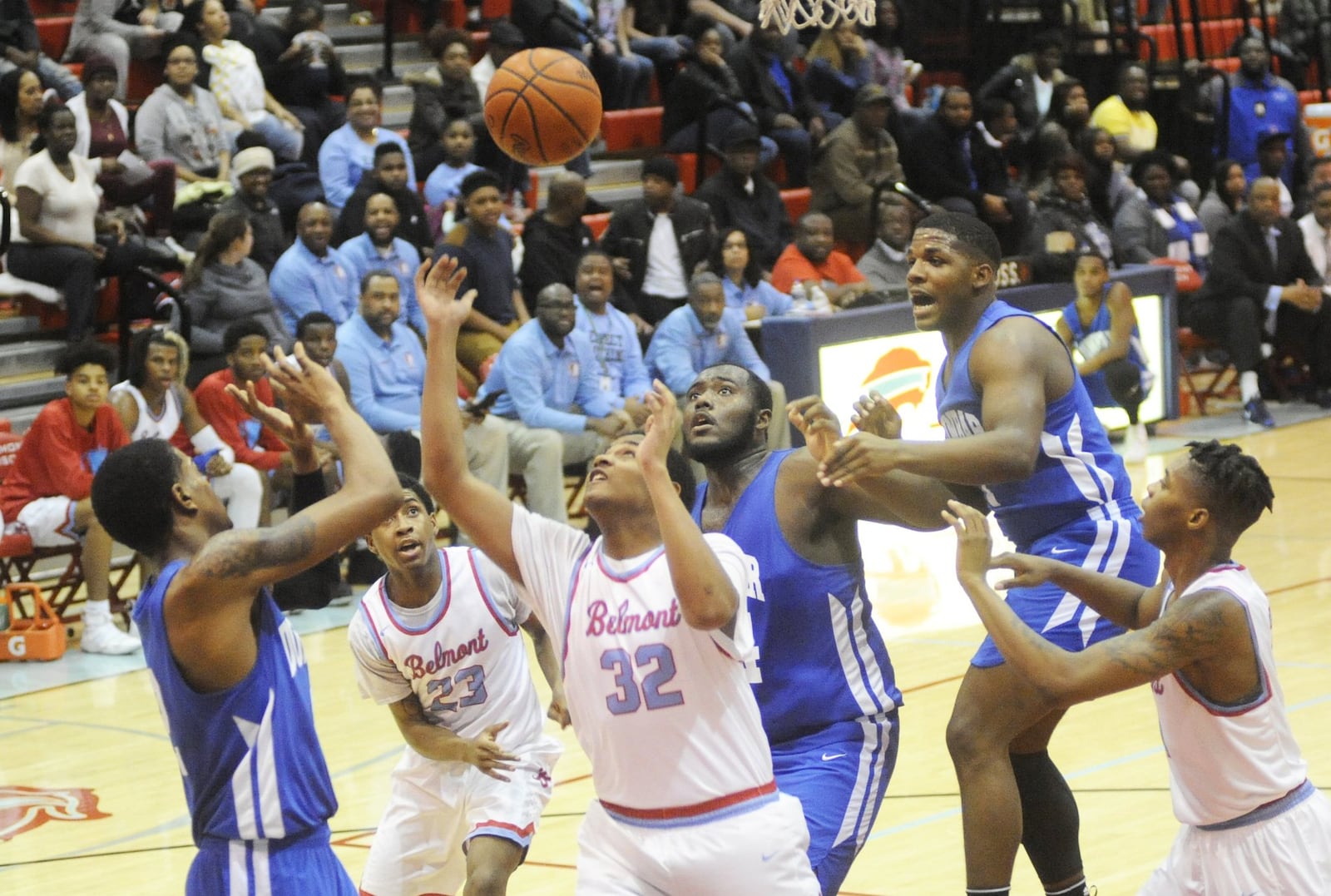 Belmont’s Daljuan Estes (32) contends with Dunbar’s Joseph Scates (left), Jonathan Allen (center) and Tavion Thomas. Dunbar defeated host Belmont 58-57 in a boys high school basketball game on Fri., Jan. 26, 2018. MARC PENDLETON / STAFF