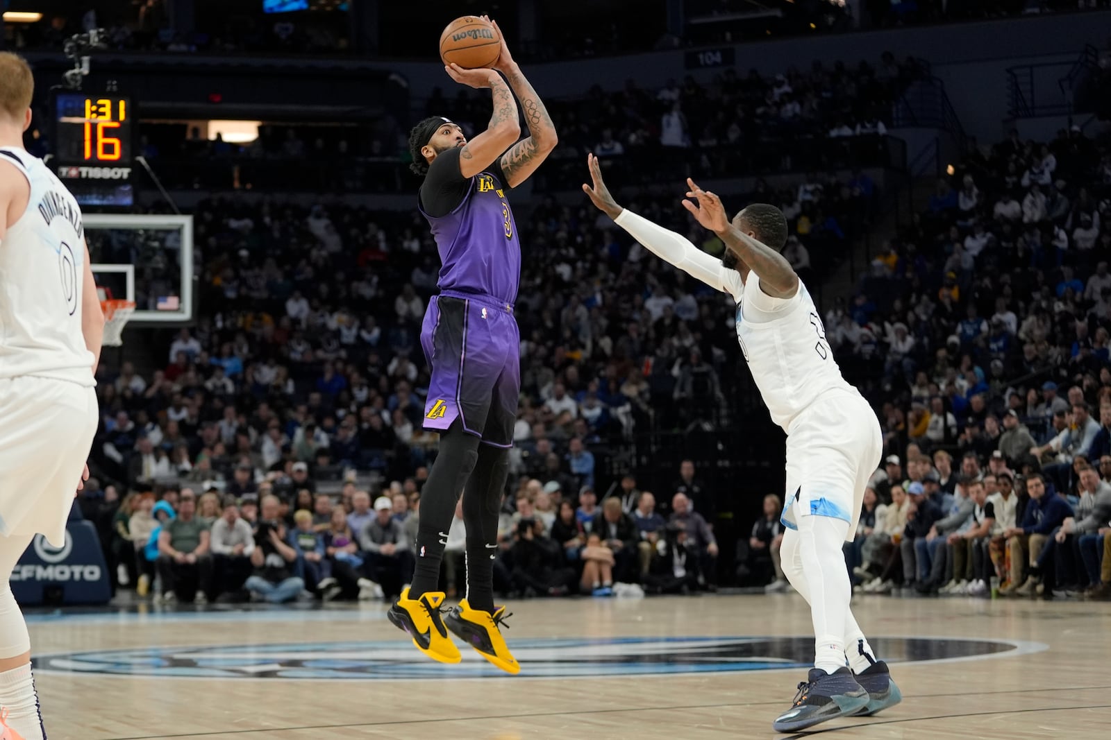 Los Angeles Lakers forward Anthony Davis (3), left, shoots over Minnesota Timberwolves forward Julius Randle (30) during the first half of an NBA basketball game, Monday, Dec. 2, 2024, in Minneapolis. (AP Photo/Abbie Parr)