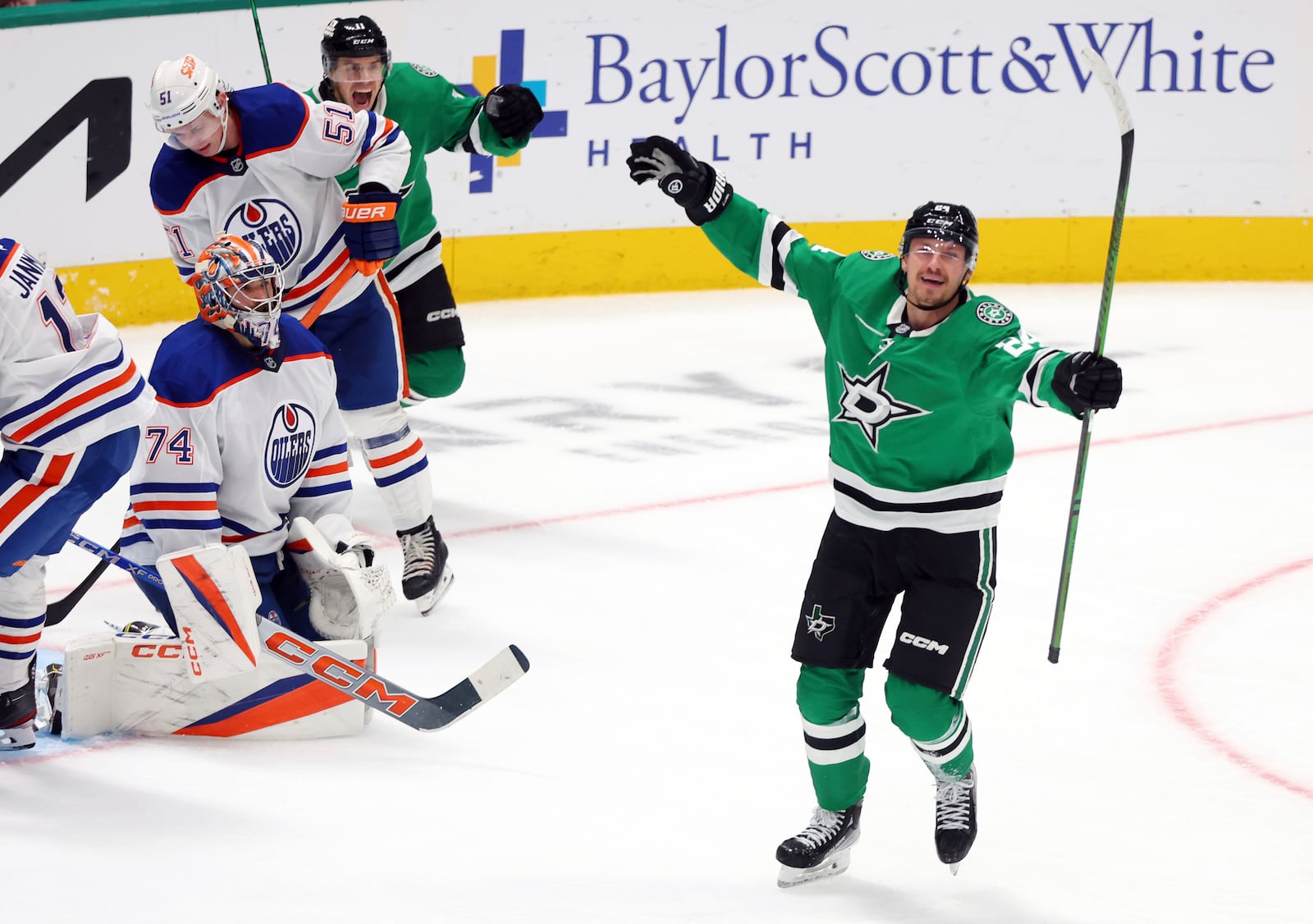 Dallas Stars centers Logan Stankoven (11) and Roope Hintz (24) celebrate after a goal against Edmonton Oilers goaltender Stuart Skinner (74) in the third period during an NHL hockey game on Saturday, Oct. 19, 2024, in Dallas. (AP Photo/Richard W. Rodriguez)