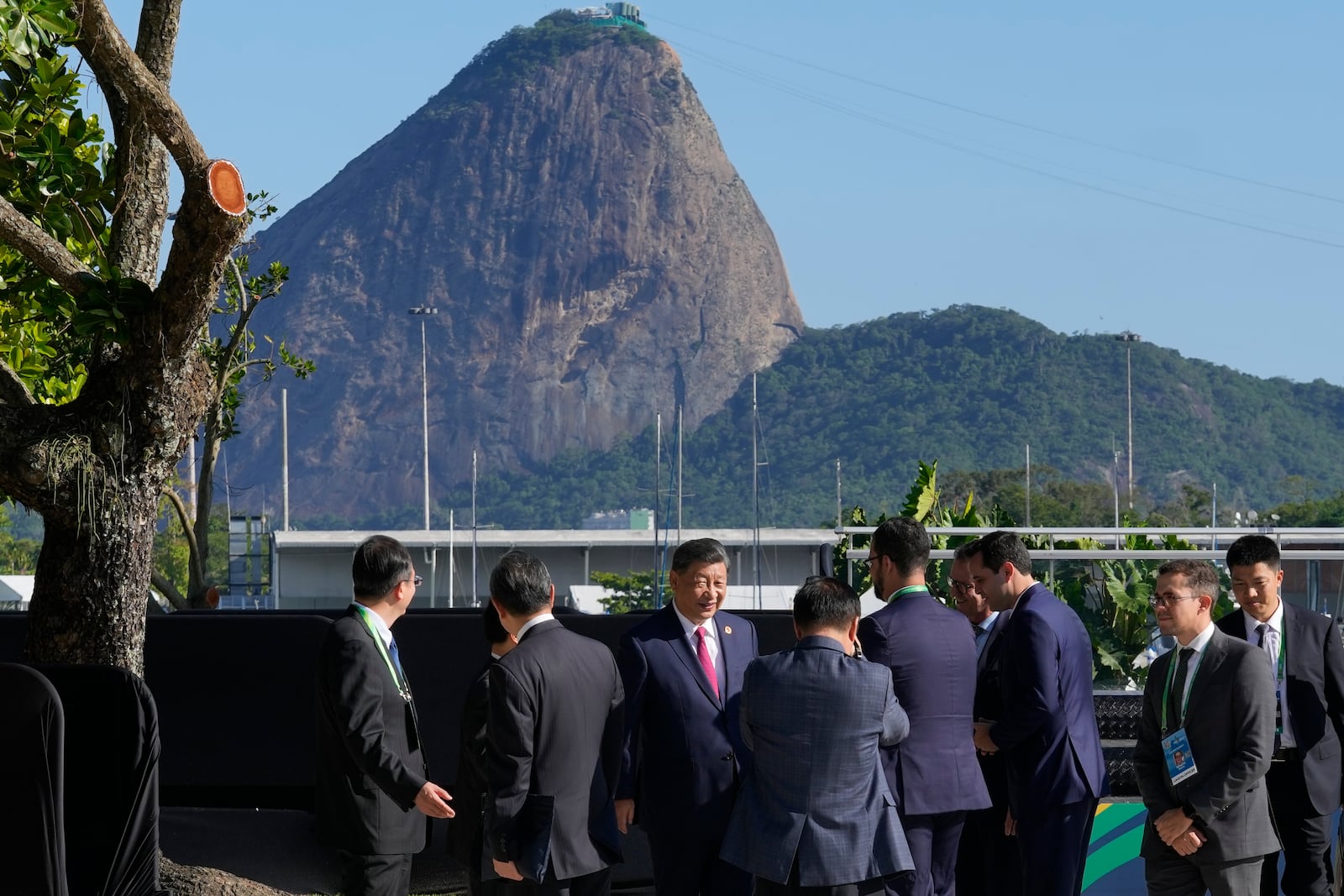 Backdropped by Sugar Loaf mountain, China's President Xi Jinping, center, walks after joining a group photo during the G20 Summit in Rio de Janeiro, Monday, Nov. 18, 2024. (AP Photo/Eraldo Peres)