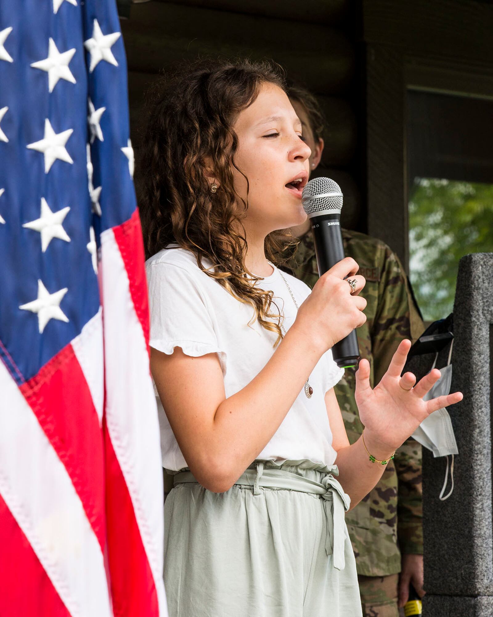 Charlotte Spaulding sings the national anthem during a ceremony recognizing the newly selected technical sergeants July 27 at Wright-Patterson Air Force Base. U.S. AIR FORCE PHOTO/JAIMA FOGG