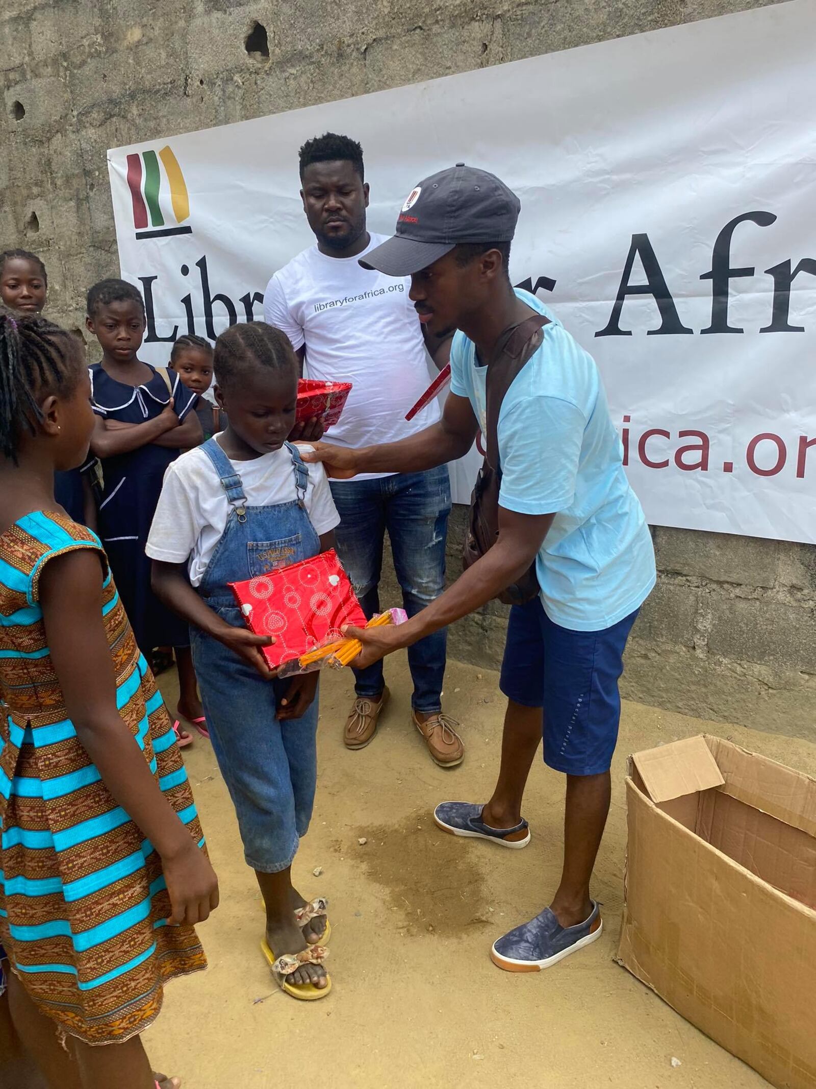 Ricks distributing educational care packages to students in Liberia.