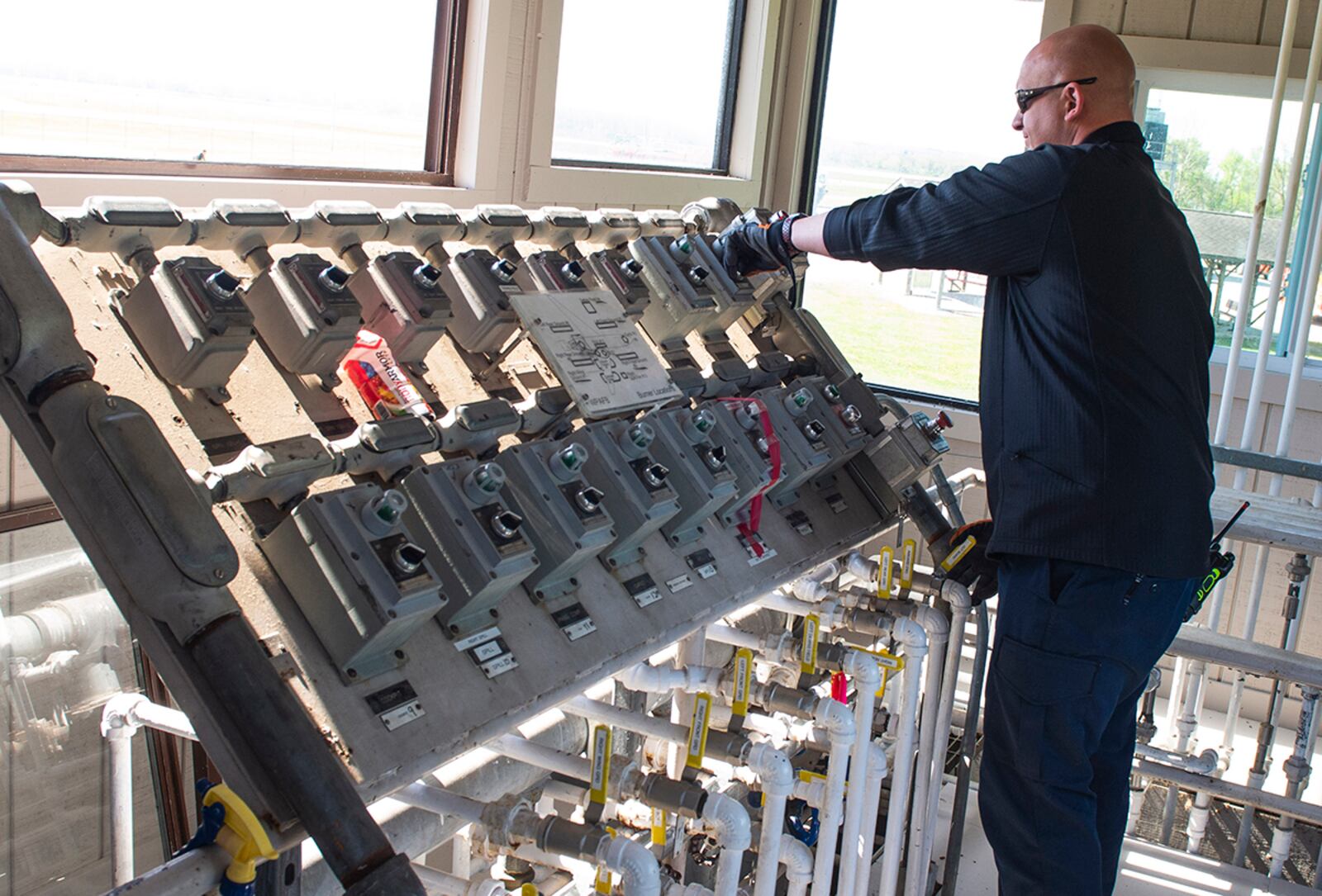 Bryan Weeks, 788th Civil Engineer Squadron fire department assistant chief, opens the valves to ignite a fire in their aircraft training fuselage at Wright-Patterson Air Force Base. U.S. AIR FORCE PHOTO/WESLEY FARNSWORTH