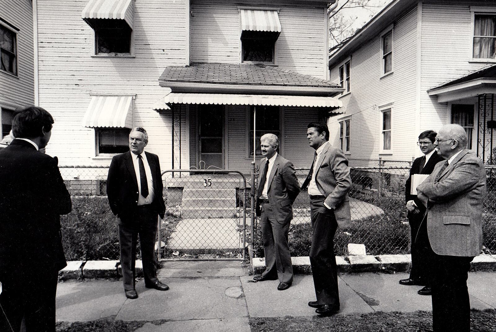 Judge Carl D. Kessler, Detective Wade Lawson, Judge William Young, Asst. Prosecutor Jom Cole and Judge Walter Porter outside the house at 35 S. Ardmore where five people died in a 1985 homicide. DAYTON DAILY NEWS ARCHIVE