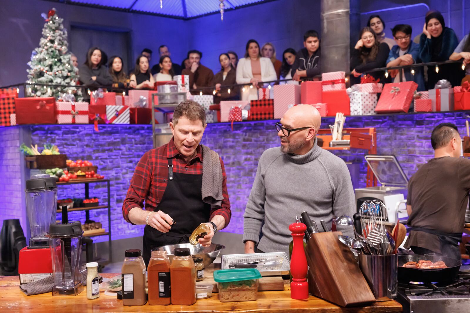 This image released by The Food Network shows Bobby Flay, left, and Michael Symon during an episode of the cooking series "Beat Bobby Flay: Holiday Throwdown." (Stephen Davis Phillips/Food Network via AP)