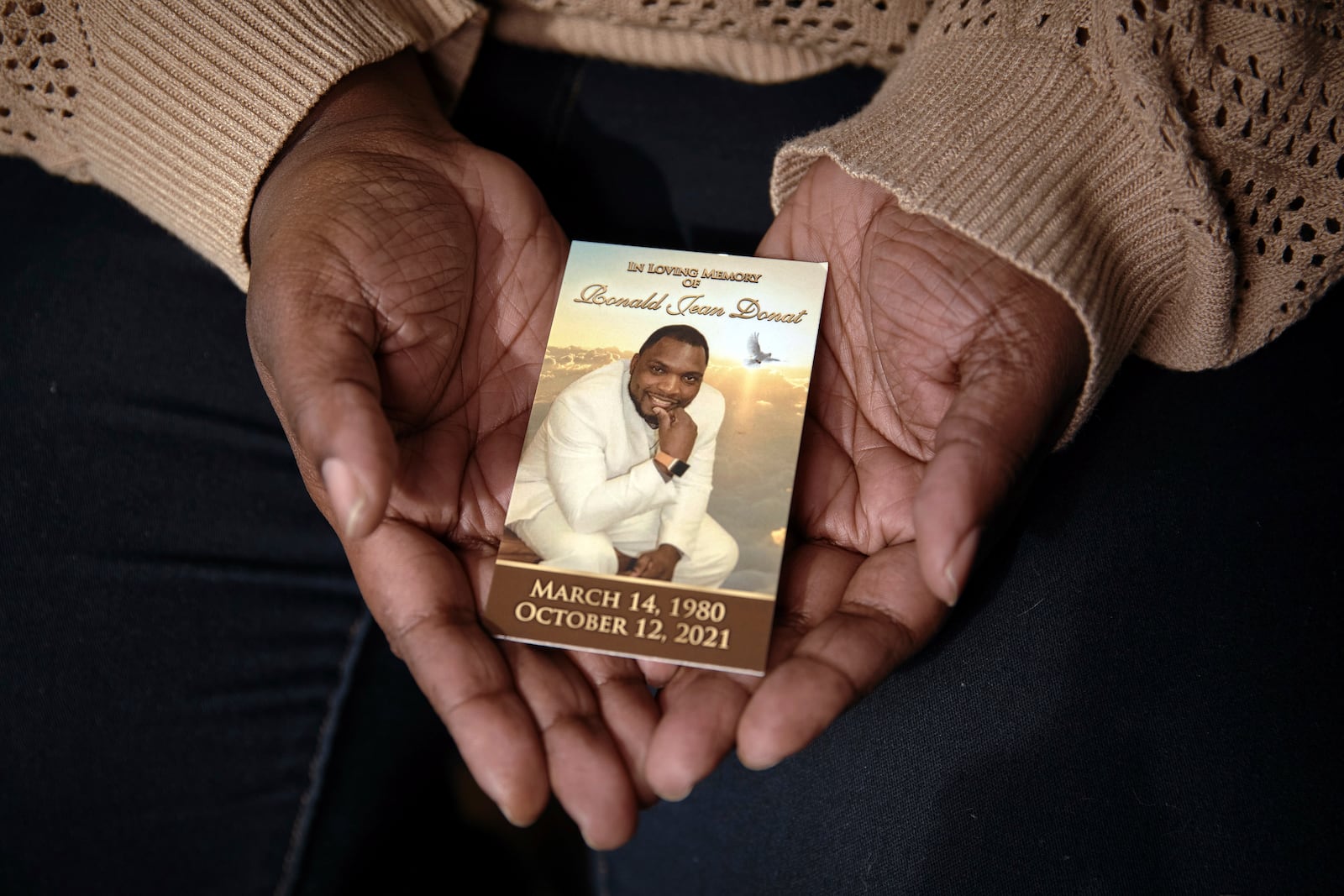 Widow Sharline Volcy holds a picture of her deceased husband, Roland Donat, Monday, Feb. 3, 2025, in Orange, N.J. (AP Photo/Andres Kudacki)