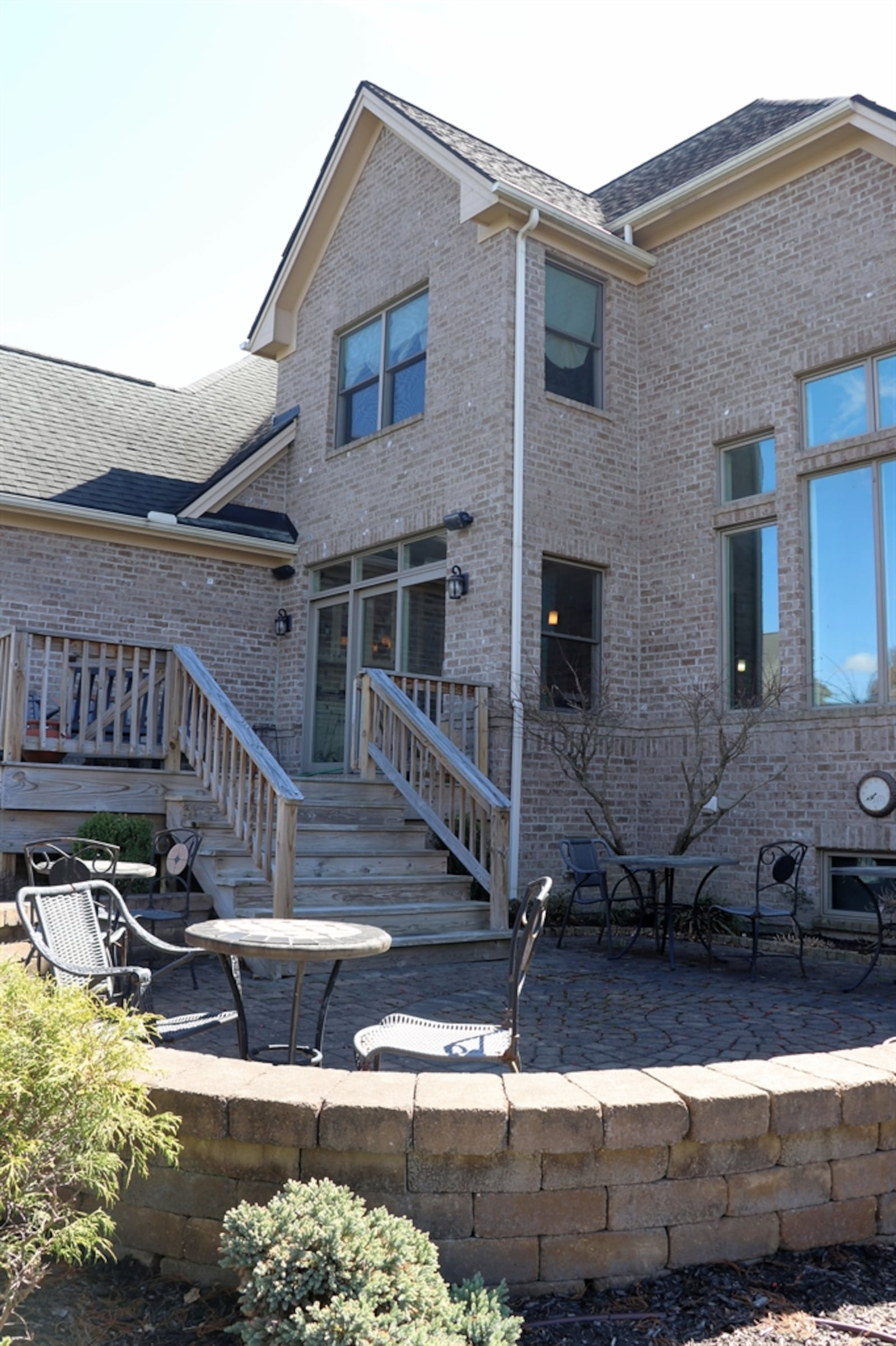 The property features island and water views from the paver-brick patio and wooden deck.