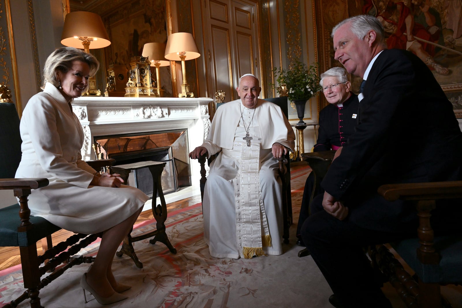 Pope Francis, center, talks to King Philippe of Belgium, right, and Queen Mathilde at the Castle of Laeken, Belgium, Friday, Sept. 26, 2024, on the second day of a four-day apostolic journey to Luxembourg and Belgium. (Alberto Pizzoli/pool photo via AP)