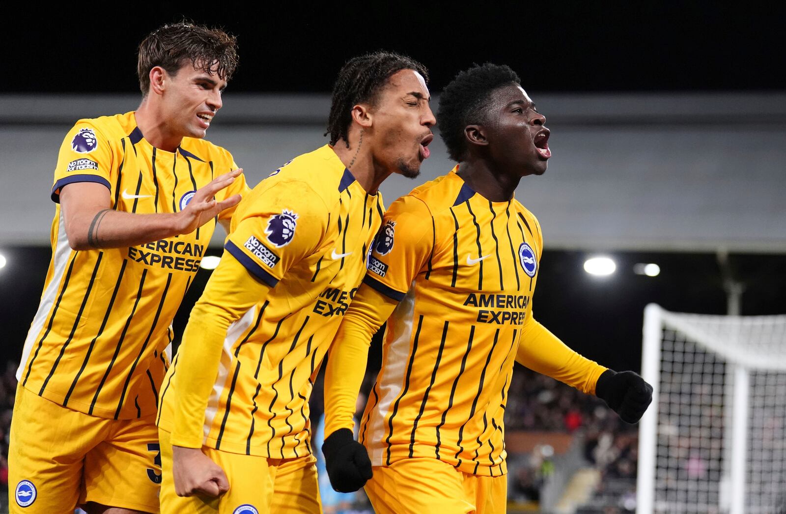 Brighton and Hove Albion's Carlos Baleba, right, celebrates after scoring his sides first goal during the English Premier League soccer match between FC Fulham and Brighton & Hove Albion in London, England, Thursday, Dec. 5, 2024. ( John Walton/PA via AP)