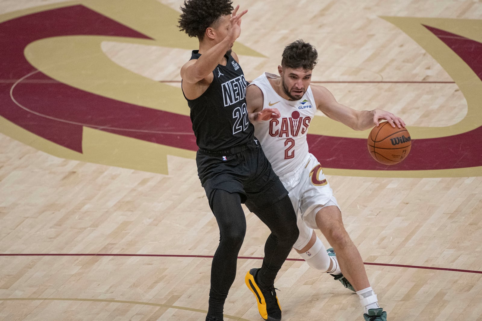 Cleveland Cavaliers' Ty Jerome (2) drives as Brooklyn Nets' Jalen Wilson (22) defends during the first half of an NBA basketball game in Cleveland, Saturday, Nov. 9, 2024. (AP Photo/Phil Long)