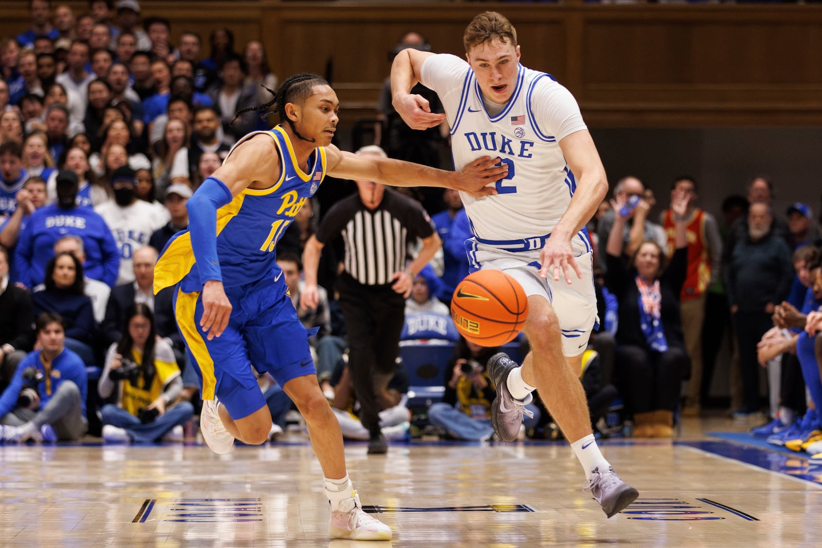 Duke's Cooper Flagg (2) gathers a loose ball for a fast break ahead of Pittsburgh's Jaland Love (15) during the second half of an NCAA college basketball game in Durham, N.C., Tuesday, Jan. 7, 2025. (AP Photo/Ben McKeown)