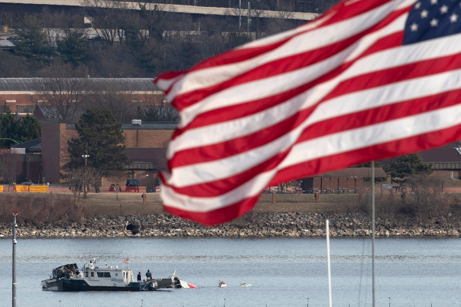 A police boat is seen around a wreckage site in the Potomac River from Ronald Reagan Washington National Airport, Thursday, Jan. 30, 2025, in Arlington, Va. (AP Photo/Jose Luis Magana)