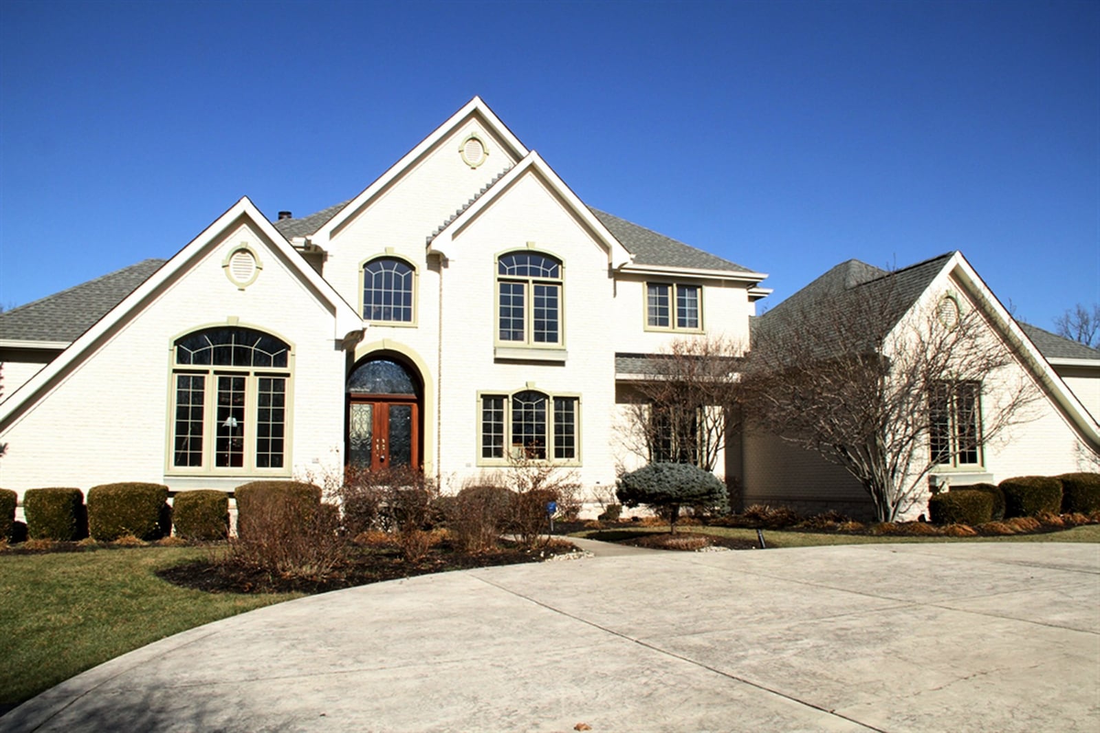 An unusual European-style chipped stone in brick sizes creates a cream color for the facade of this 2-story home in Lebanon. Gabled rooftops are nested at the center, which is flanked with more steeply slanted rooftops above the two main wings of the home. A circle in stamped concrete in front of the home connects to two paved driveways, one for entering from the road and one leading to the parking pad and side-entry garages. CONTRIBUTED PHOTOS BY KATHY TYLER