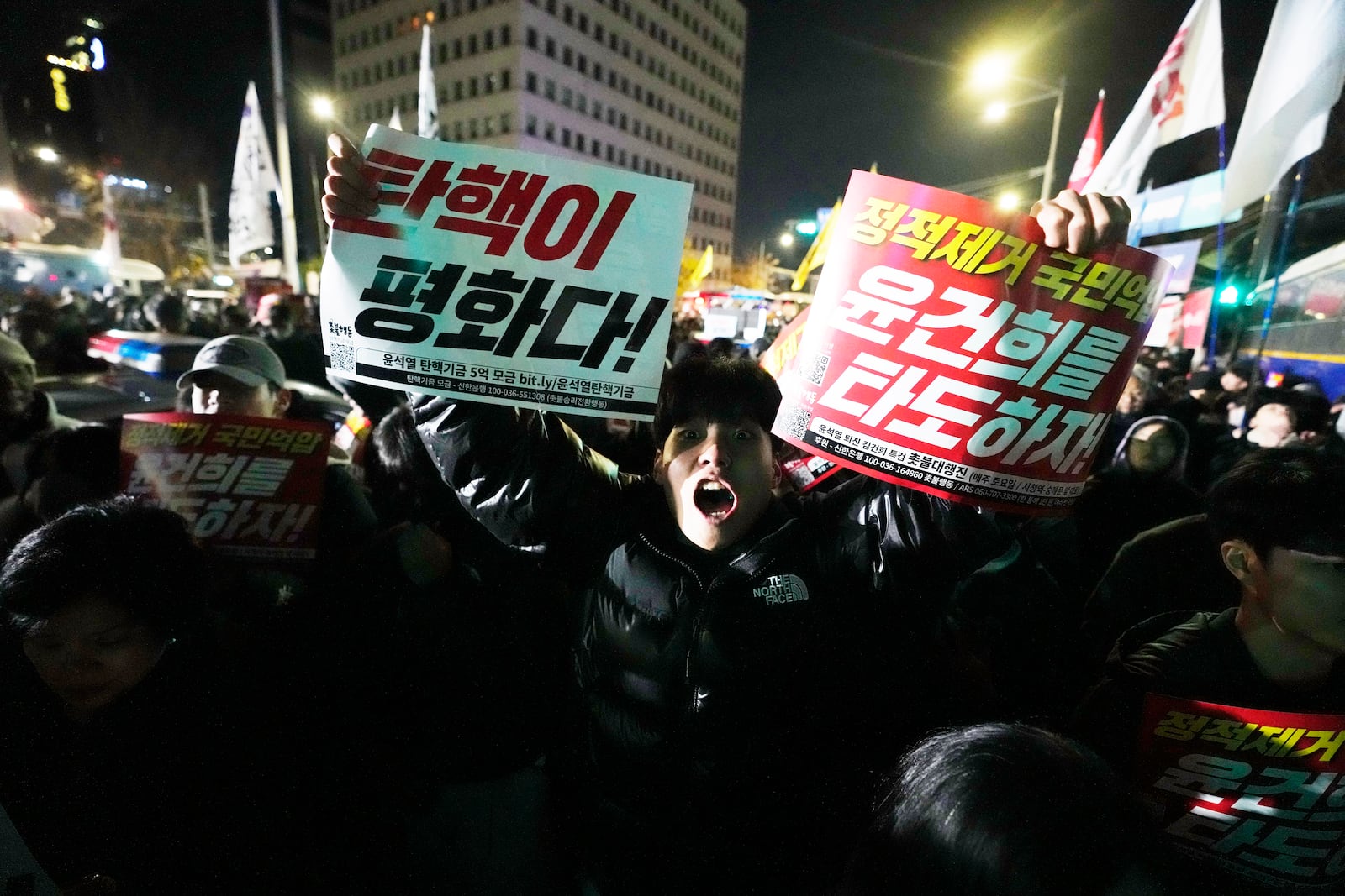 A man shouts to demand South Korean President Yoon Suk Yeol to step down in front of the National Assembly in Seoul, South Korea, Wednesday, Dec. 4, 2024. (AP Photo/Ahn Young-joon)