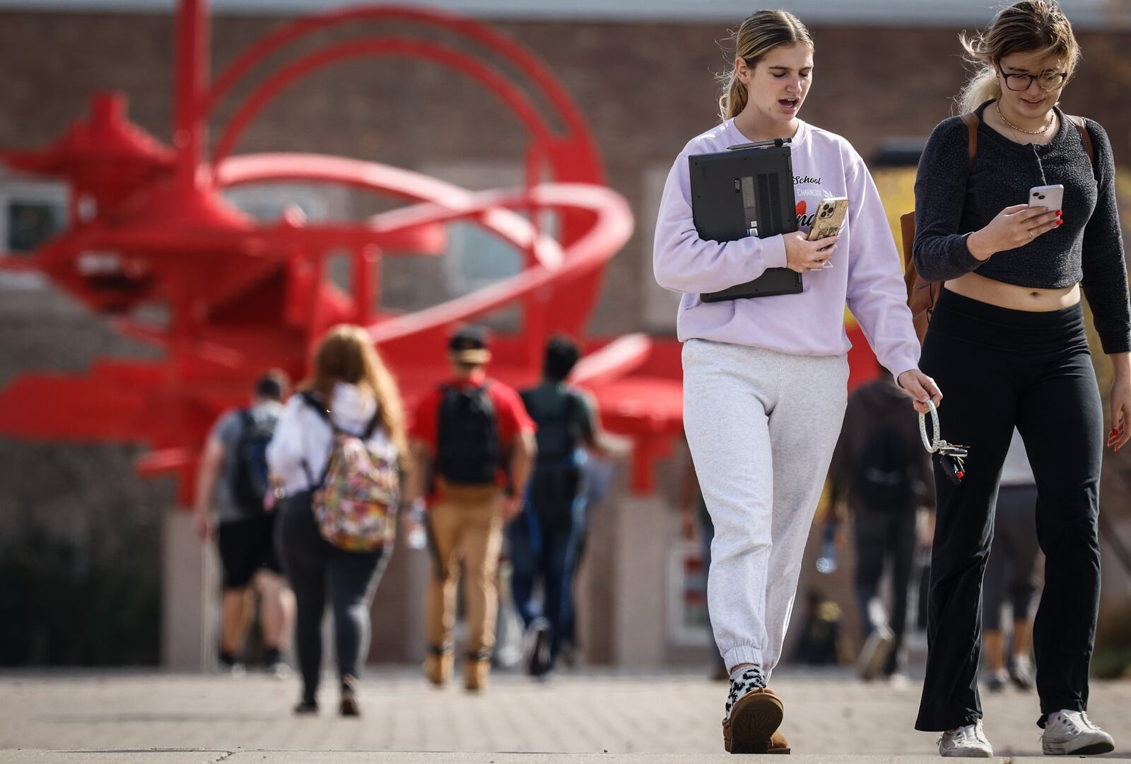 Students a Wright State University walk to and from class at the university October 24, 2022. Enrollment at public universities in Ohio has fallen and tuition has gone up. JIM NOELKER/STAFF