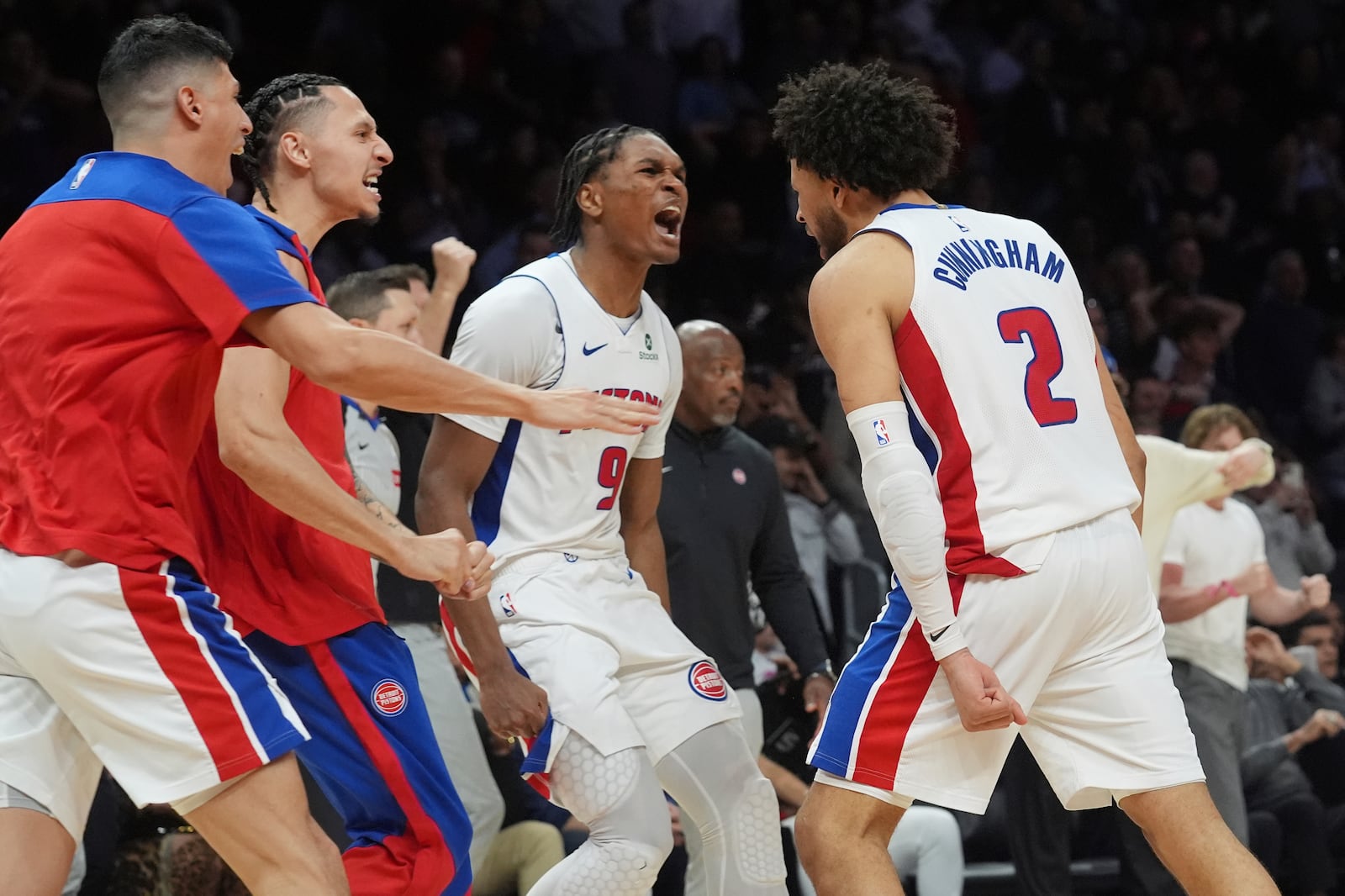 Detroit Pistons guard Cade Cunningham (2) is cheered by his teammates after scoring the winning basket during the second half of an NBA basketball game against the Miami Heat, Wednesday, March 19, 2025, in Miami. (AP Photo/Marta Lavandier)