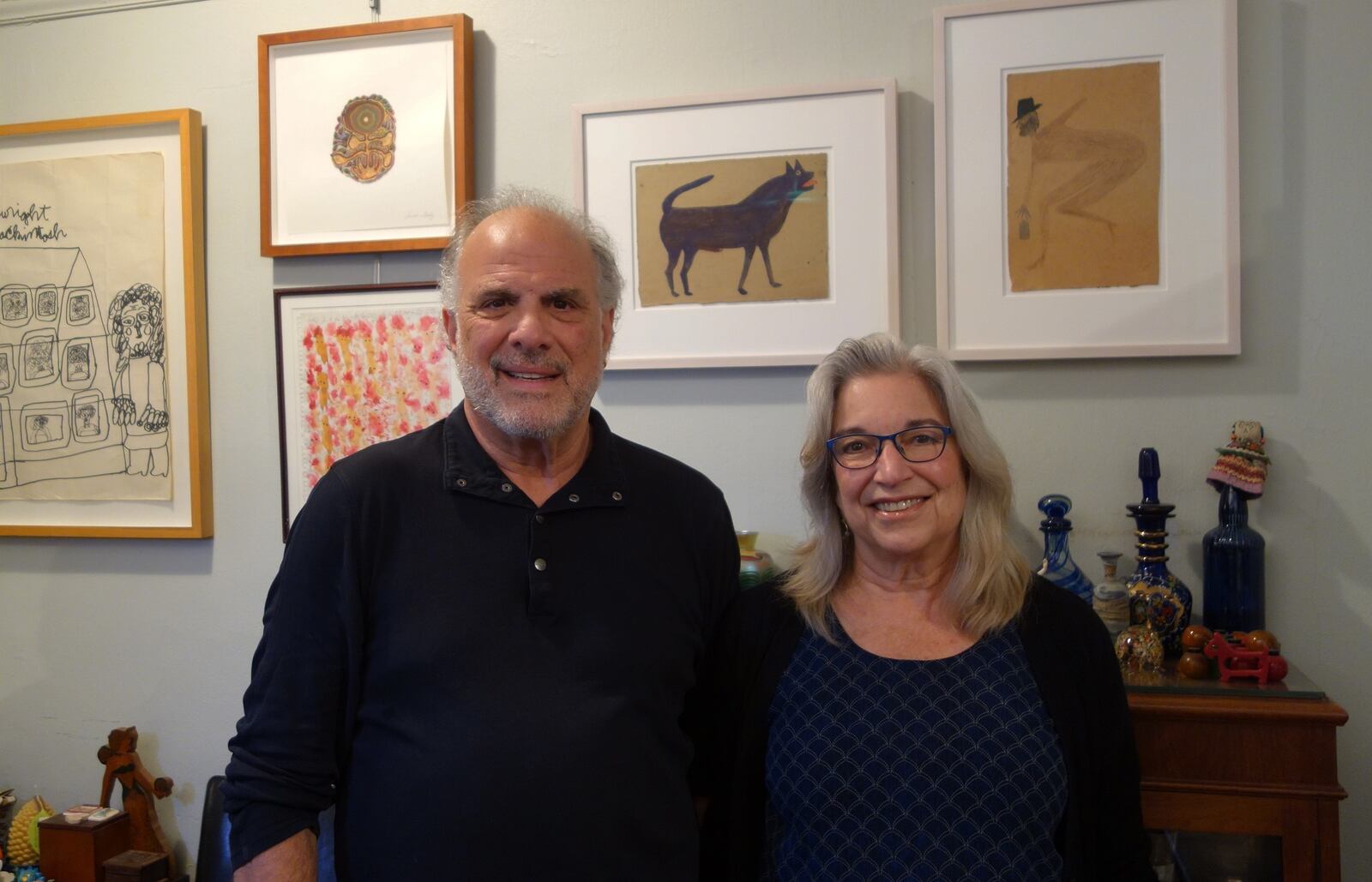 Jeany and Jeffrey Wolf are pictured with art by visionary artist Bill Traylor, the subject of their documentary. CONTRIBUTED