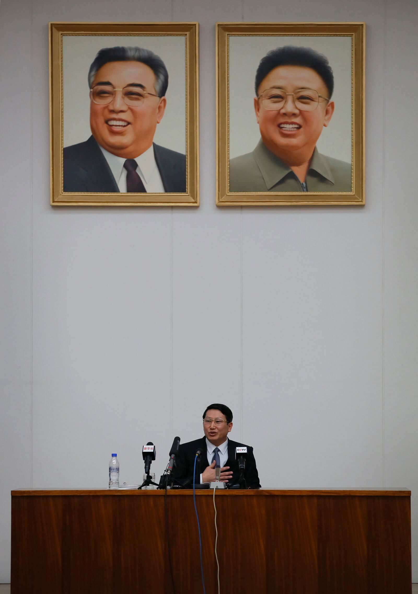 FILE - Kim Jung Wook, a South Korean Baptist missionary, speaks under portraits of late leaders Kim Il Sung, left, and Kim Jong Il during a news conference in Pyongyang, North Korea, Feb. 27, 2014. (AP Photo/Vincent Yu, File)