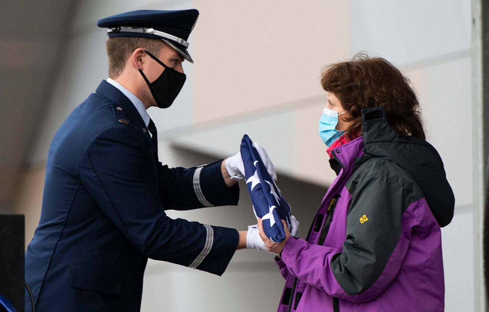 A ceremonial guardsman from Wright-Patterson Air Force Base presents the American flag to Victoria Yeager during the “Celebration of Life” service for Retired Brig. Gen. Chuck Yeager at the Charleston Coliseum & Convention Center in West Virginia on Jan. 15, 2021. U.S. AIR FORCE PHOTO/WESLEY FARNSWORTH