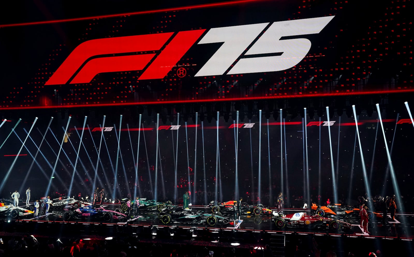 Drivers stand with their new cars during the F1 75 Live event at the O2 arena in London, Tuesday, Feb. 18, 2025.(Bradley Collyer/PA via AP)