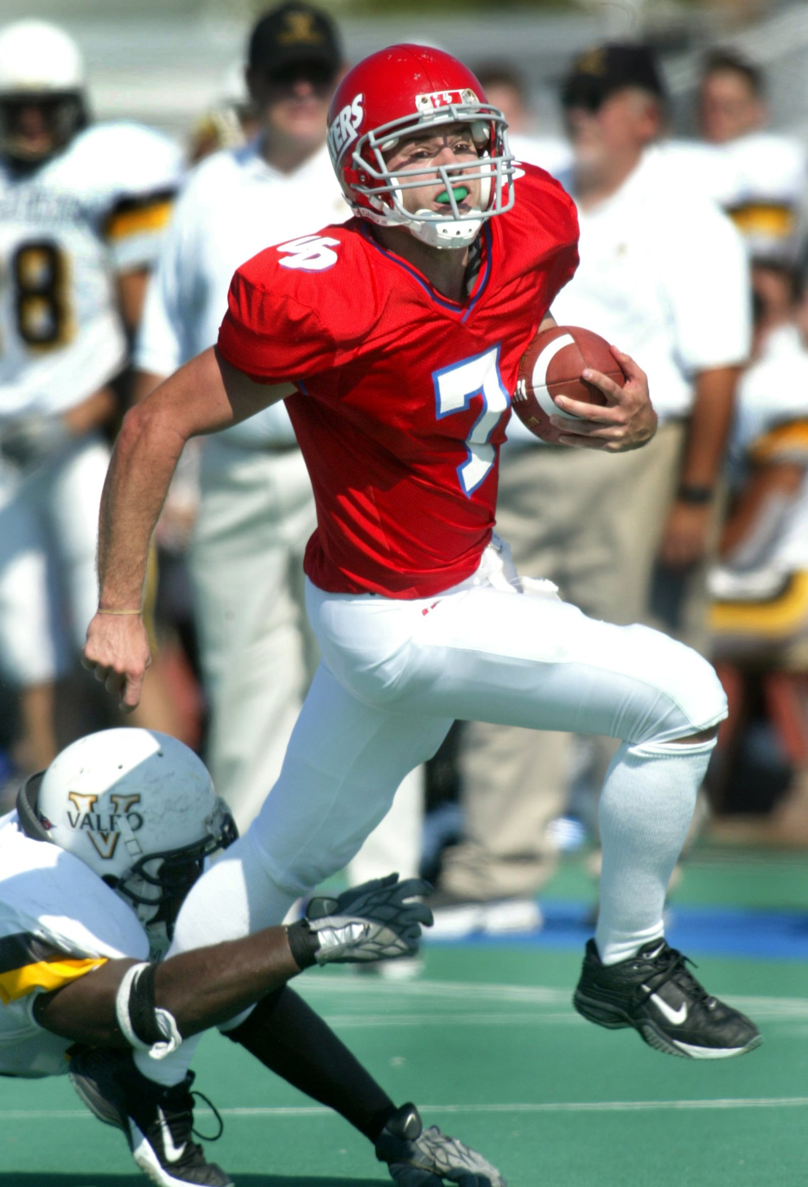 Brandon Staley, the Flyers starting quarterback, evades a Valparaiso tackler while picking up a second quarter first down. Dayton hosted and lost the game by a score of 33 to 28.