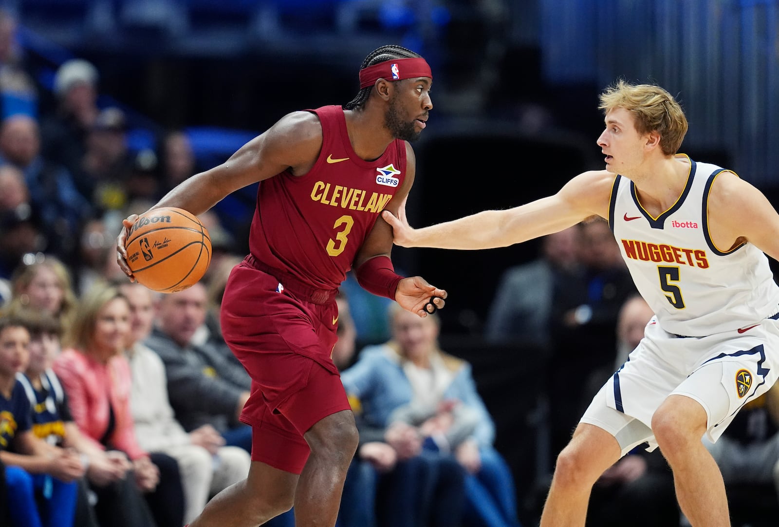 Cleveland Cavaliers guard Caris LeVert, left, looks to drive to the basket as Denver Nuggets forward Hunter Tyson, right, defends in the first half of an NBA basketball game Friday, Dec. 27, 2024, in Denver. (AP Photo/David Zalubowski)