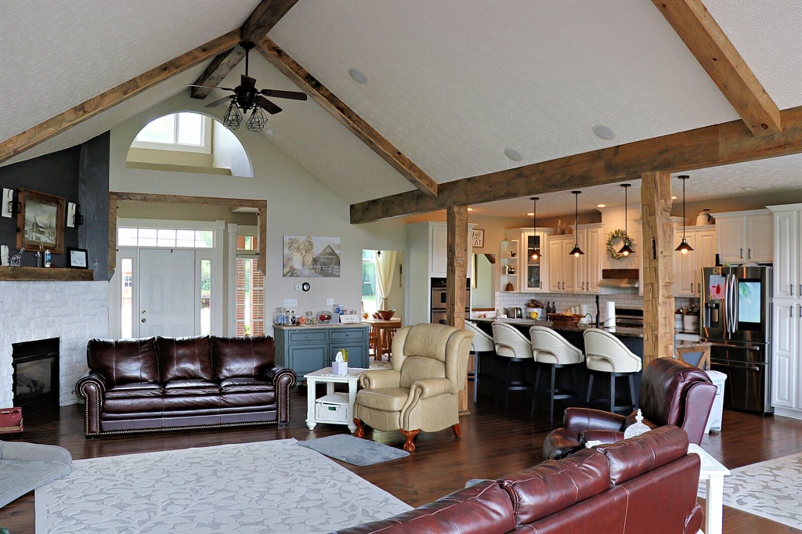 Rough-cut wood beams accent the cathedral ceiling above the great room and offsets the kitchen and breakfast room. 