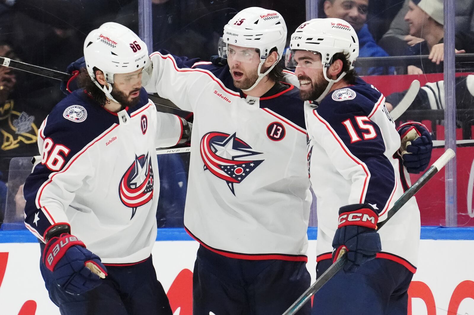 Columbus Blue Jackets' Adam Fantilli celebrates his goal against the Toronto Maple Leafs with Kirill Marchenko and Dante Fabbro (15) during the second period of an NHL hockey game in Toronto on Wednesday, Jan. 22, 2025. (Frank Gunn/The Canadian Press via AP)