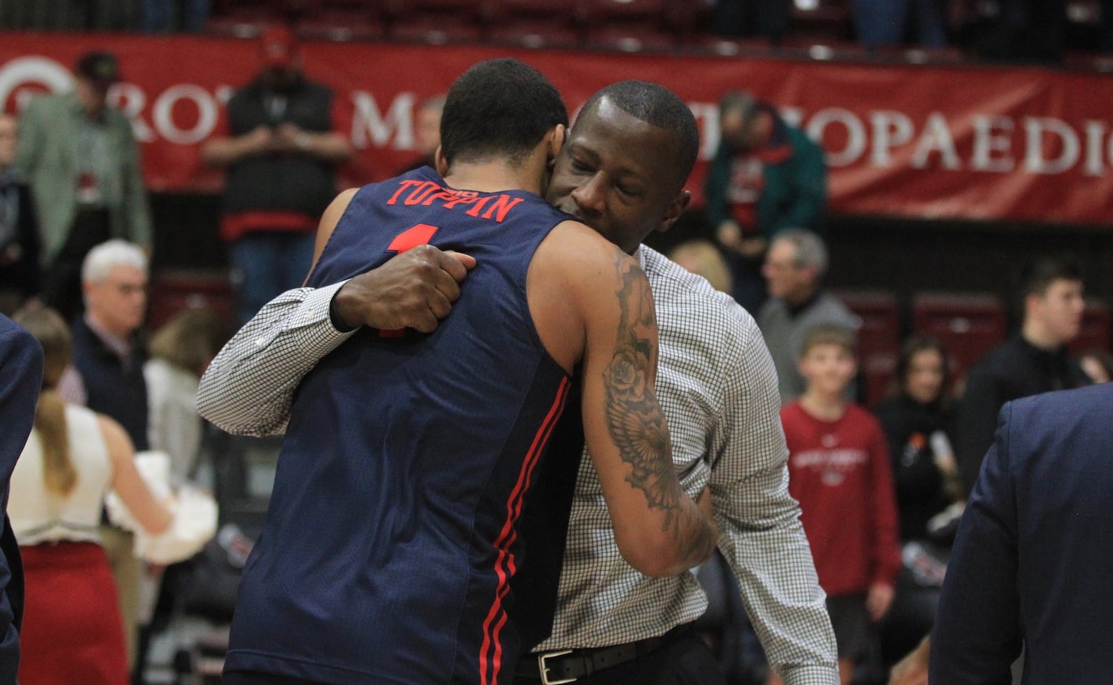 Dayton’s Anthony Grant hugs Obi Toppin after a victory against Saint Joseph’s on Sunday, Jan. 5, 2020, at Hagan Arena in Philadelphia. David Jablonski/Staff