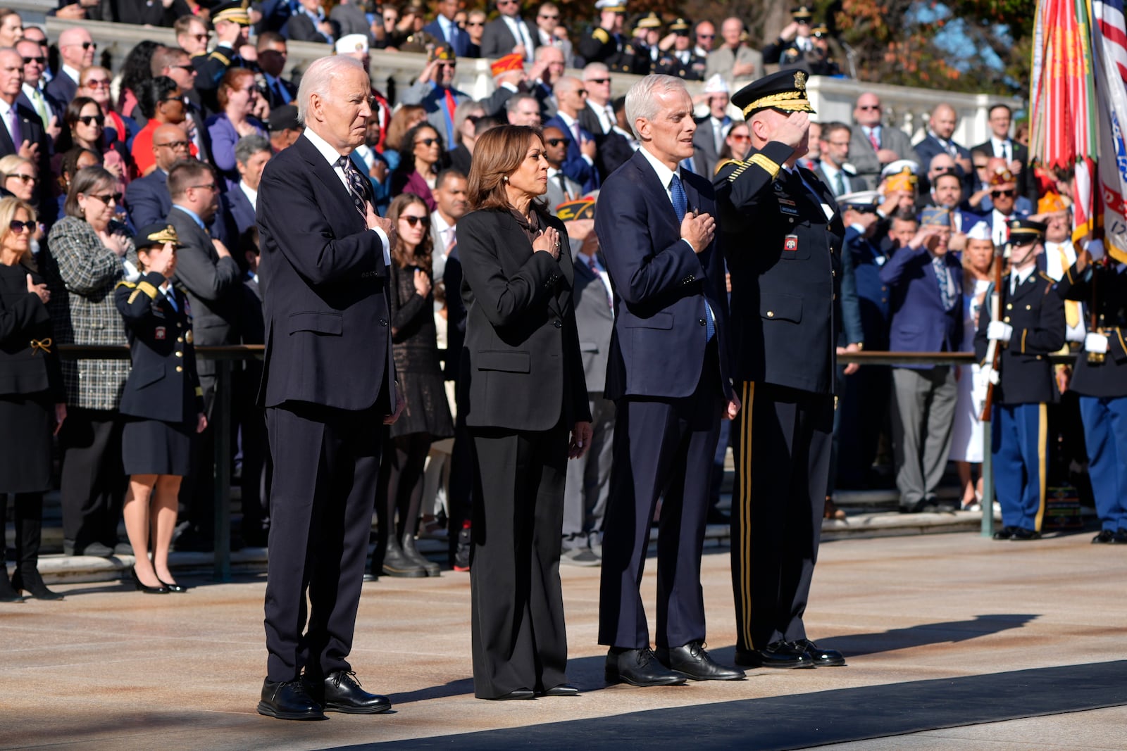 President Joe Biden, from left, Vice President Kamala Harris, Veterans Affairs Secretary Denis McDonough and Maj. Gen. Trevor Bredenkamp, commanding general of the Joint Task Force-National Capital Region and the U.S. Military District of Washington, stand during a wreath laying ceremony at the Tomb of the Unknown Soldier on National Veterans Day Observance at Arlington National Cemetery in Arlington, Va., Monday, Nov. 11, 2024. (AP Photo/Mark Schiefelbein)