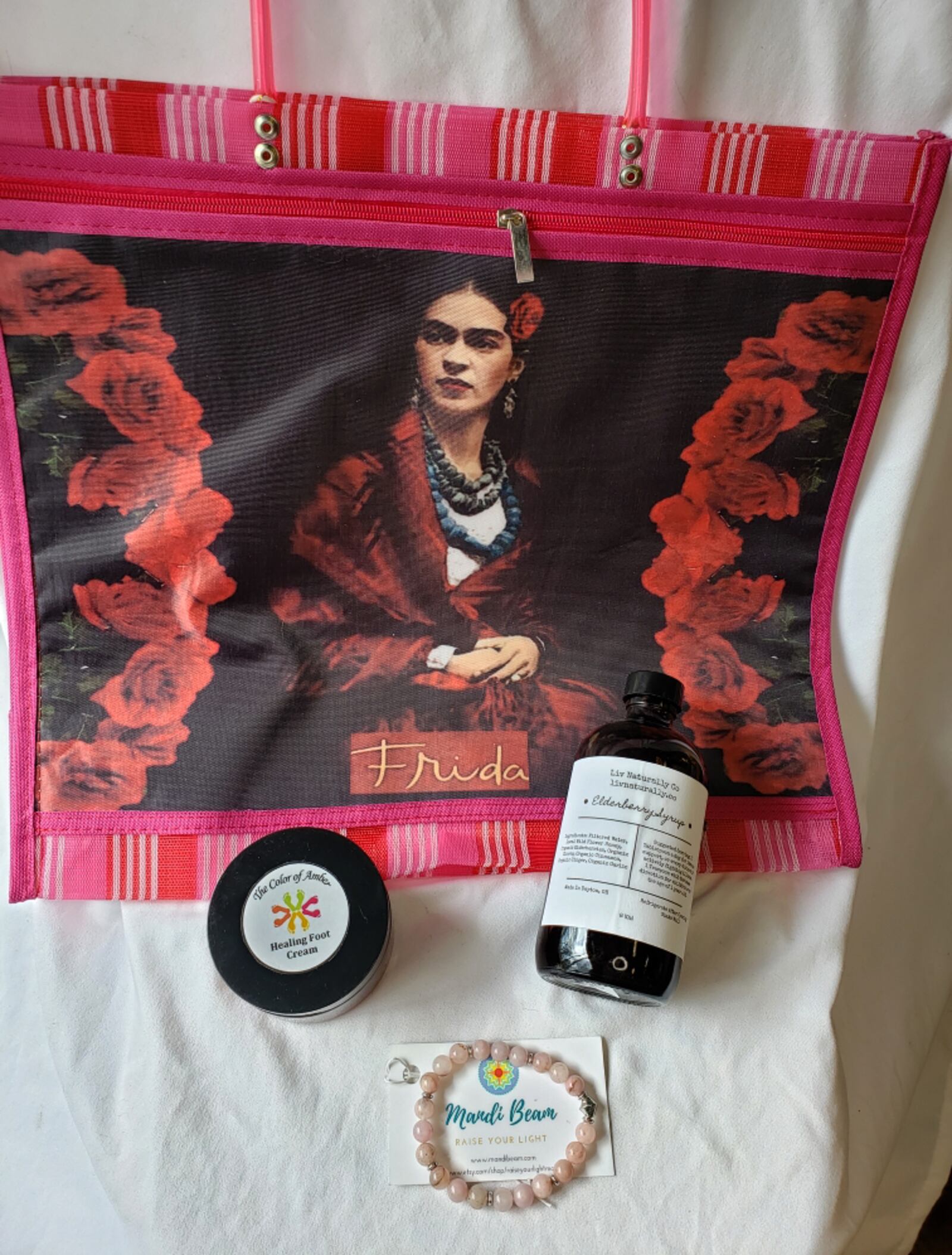 The âHealing Artâ bundle ($70), a combination of a Frida Kahlo tote by Ixchel Studio, elderberry syrup from Liv Natually Co., Healing Foot Cream from The Color of Amber and a rose quartz bracelet made by Mandi Beam. CONTRIBUTED PHOTO