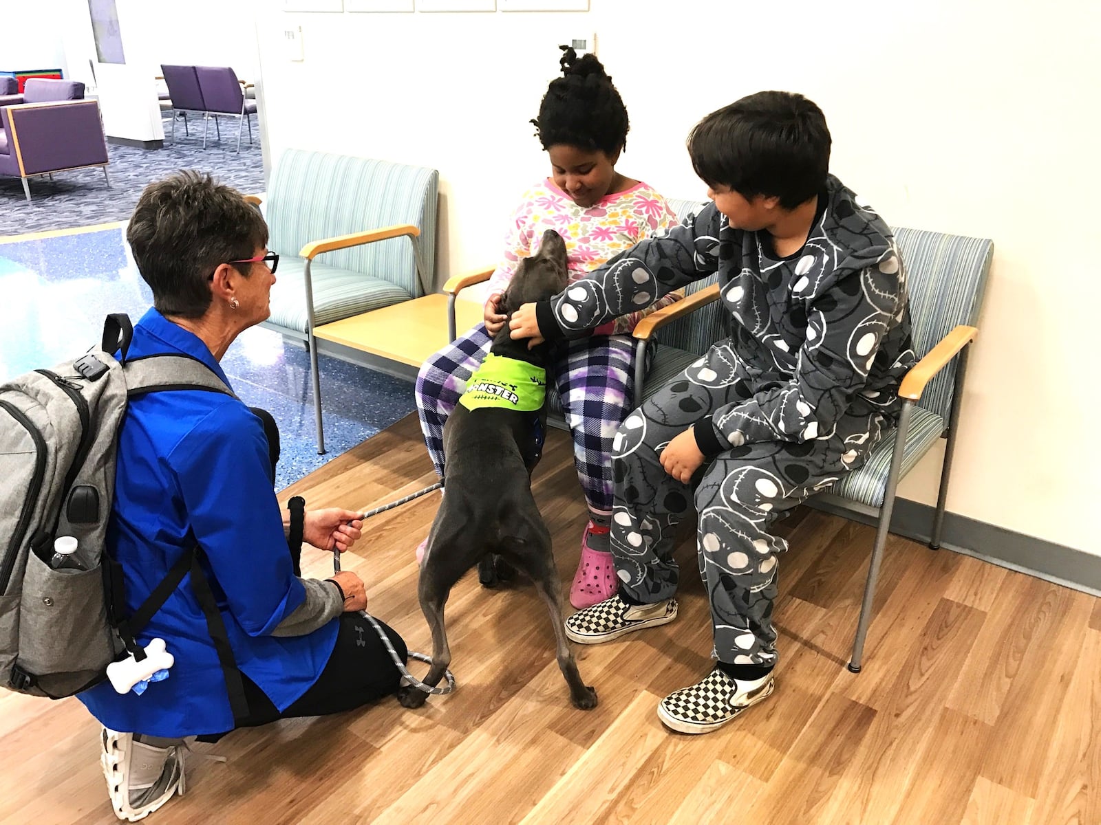 Winter Liske, an eight-year-old third grader at Belle Haven Elementary  and her 10-year-old brother Geody, a Belle Haven fifth grader, spend some time with Dash as they wait for their four year old brother Eric to finish his appointment with an ENT special at Dayton Children’s South. Tom Archdeacon/CONTRIBUTED