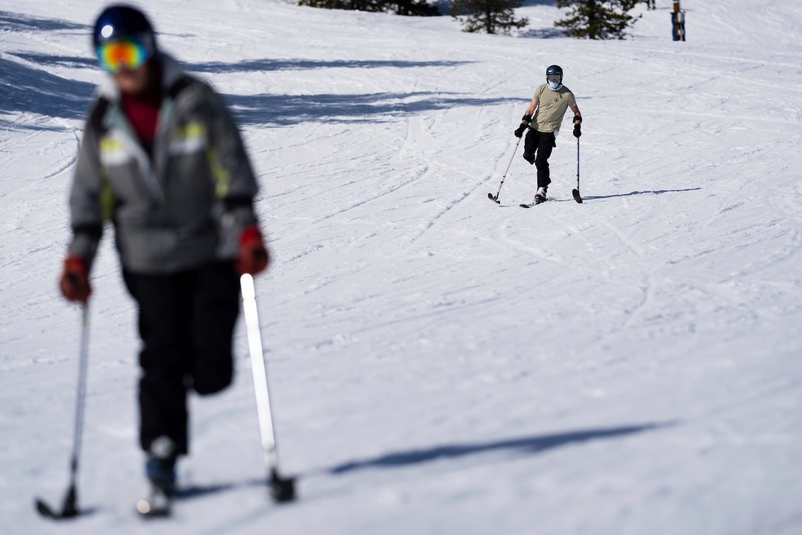 Ukrainian veteran Stanislav Povkhan, center, participates in a lesson with Oregon Adaptive Sports on the three track skiing method at Hoodoo Ski Area in central Oregon on Thursday, March 6, 2025. (AP Photo/Jenny Kane)