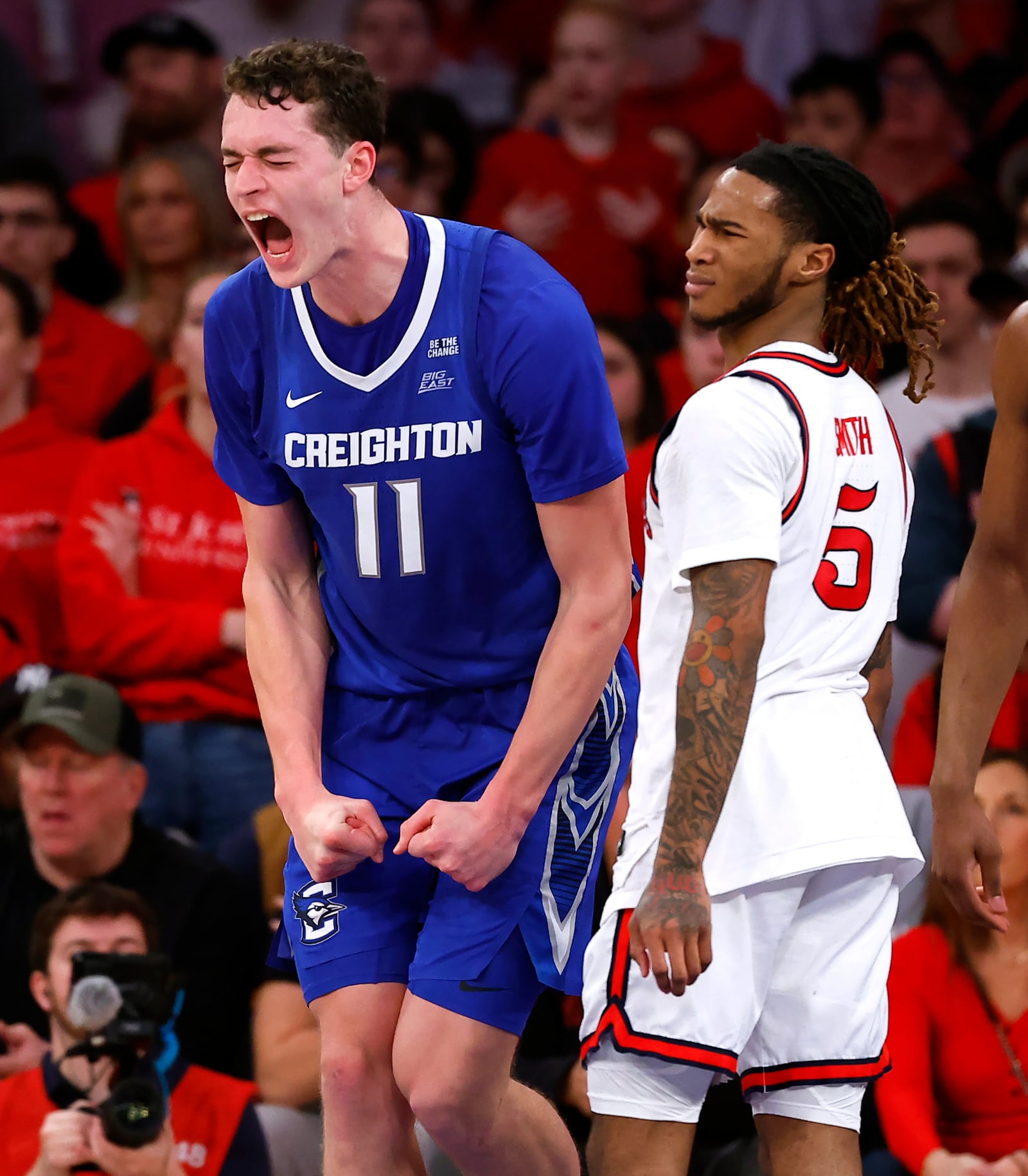 Creighton center Ryan Kalkbrenner (11) reacts after scoring against St. John's guard Deivon Smith (5) during the second half of an NCAA college basketball game, Sunday, Feb. 16, 2025, in New York. (AP Photo/Noah K. Murray)