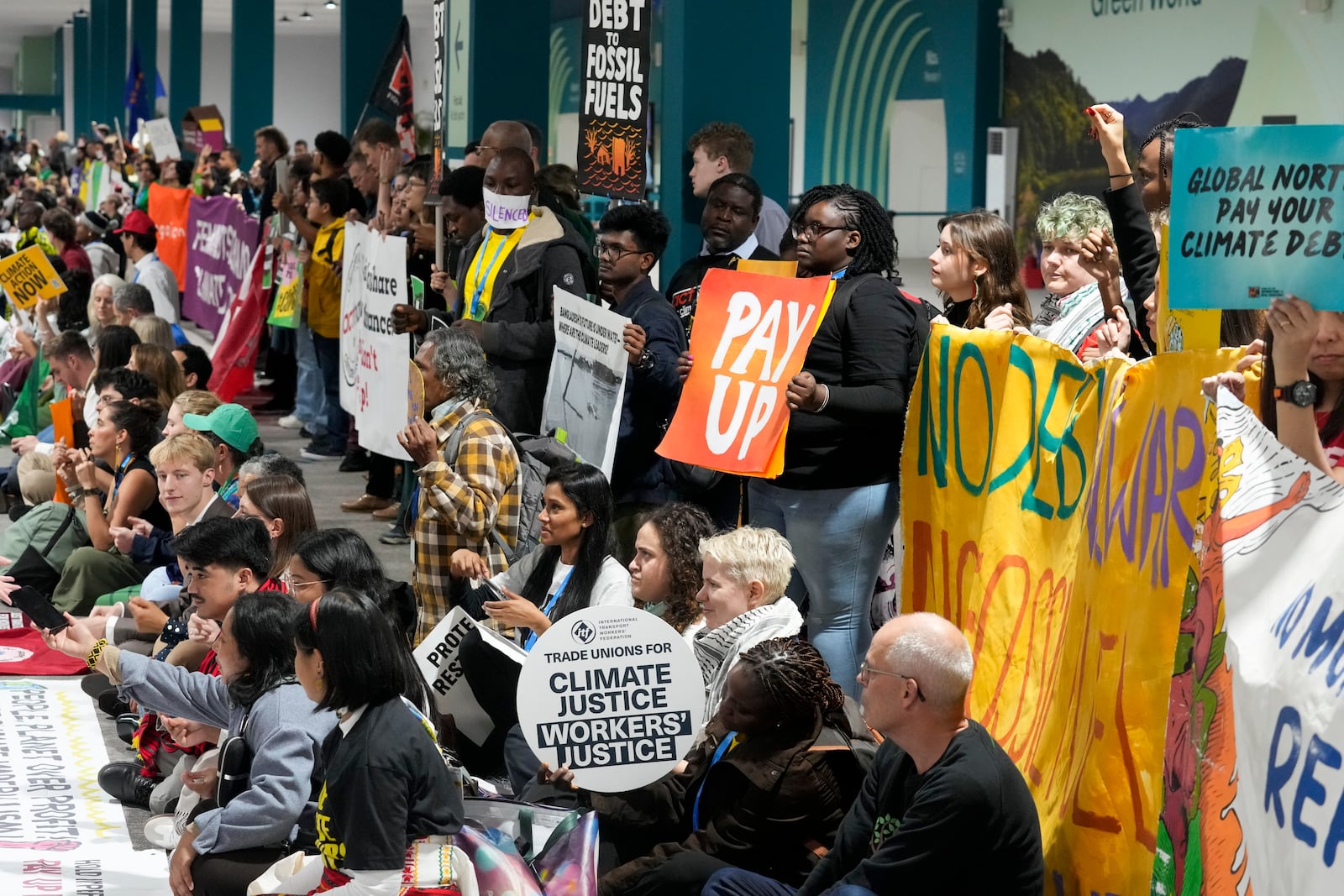 Activists participate in a demonstration at the COP29 U.N. Climate Summit, Saturday, Nov. 16, 2024, in Baku, Azerbaijan. (AP Photo/Rafiq Maqbool)