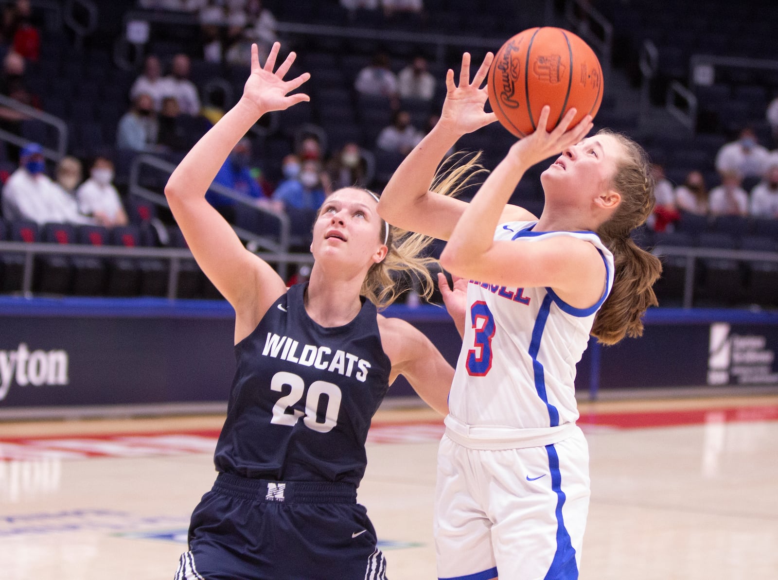 Carroll's Sarah Ochs puts up a shot against Napoleon's Taylor Strock during a Division II state semifinal game at UD Arena on Friday, March 12, 2021. Jeff Gilbert/CONTRIBUTED