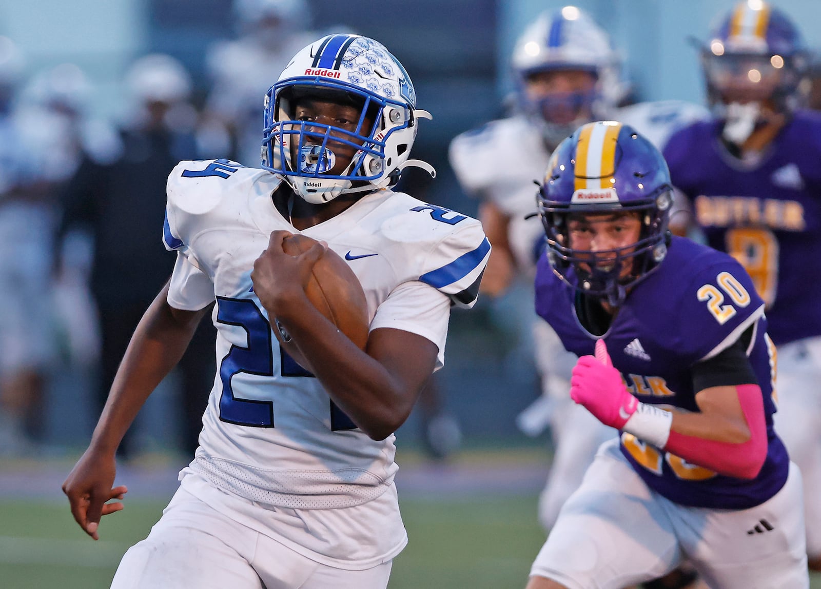 Xenia's Deaunte White is chased by Butler's Brody Miller as he carries the ball. BILL LACKEY/STAFF