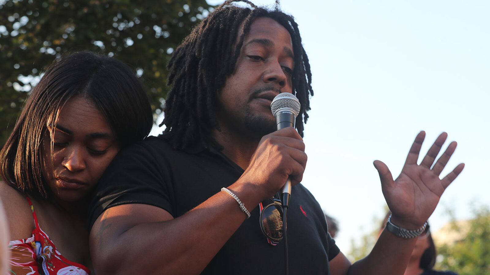 Dion Green, the son of Derrick Fudge, who was killed in the Dayton, Ohio, mass shooting, speaks during a candlelight vigil Monday evening in downtown Springfield.