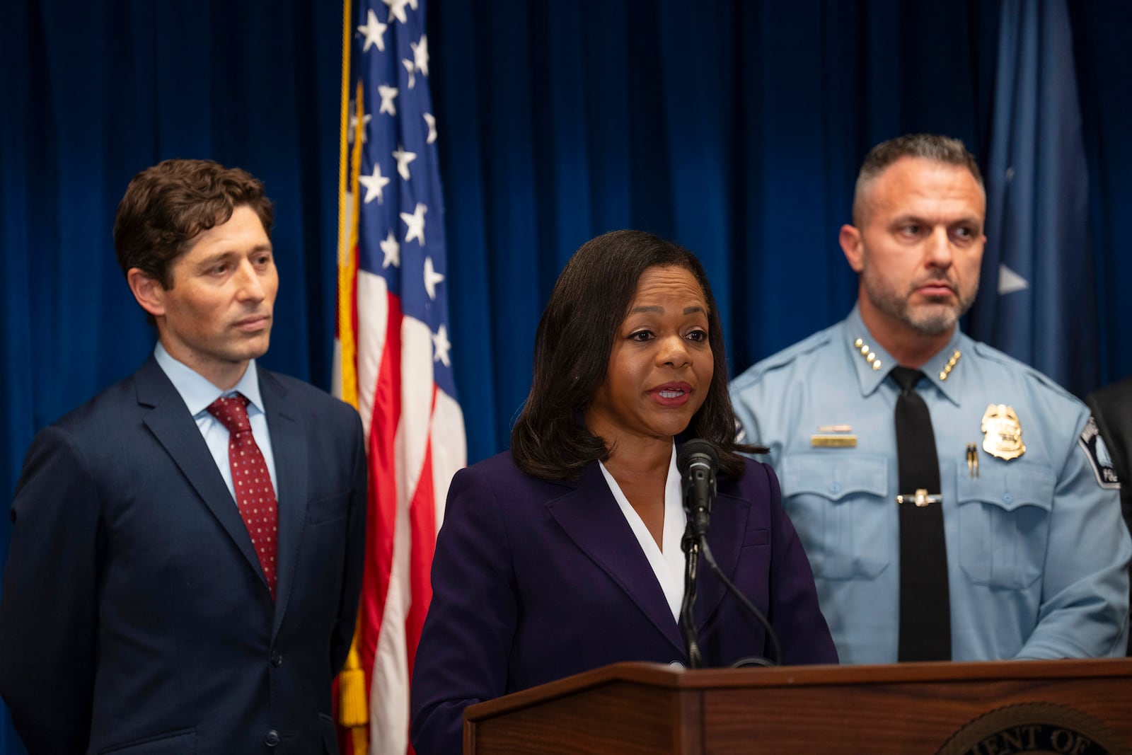 Assistant Attorney General Kristen Clarke of the Justice Department's Civil Rights Division, flanked by Minneapolis Mayor Jacob Frey, left, and Chief Brian O'Hara of the Minneapolis Police Department, speaks at a news conference after the Minneapolis City Council approved a settlement agreement with the U.S. Department of Justice approving a federal consent decree, at the U.S. Courthouse in Minneapolis, Monday, Jan. 6, 2025. (Jeff Wheeler/Star Tribune via AP)