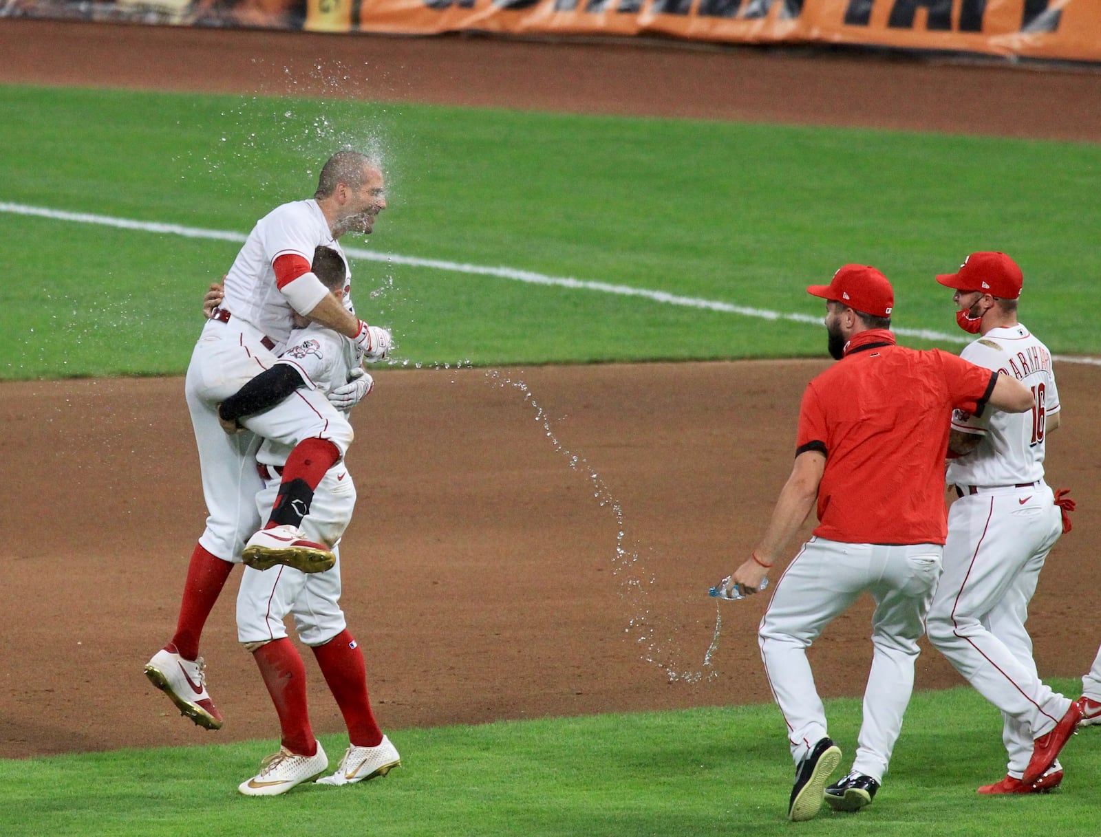 The Reds' Joey Votto, left, and Nick Senzel celebrate after Votto's game-winning double in the 10th inning against the Royals on Tuesday, Aug. 11, 2020, at Great American Ball Park in Cincinnati. David Jablonski/Staff