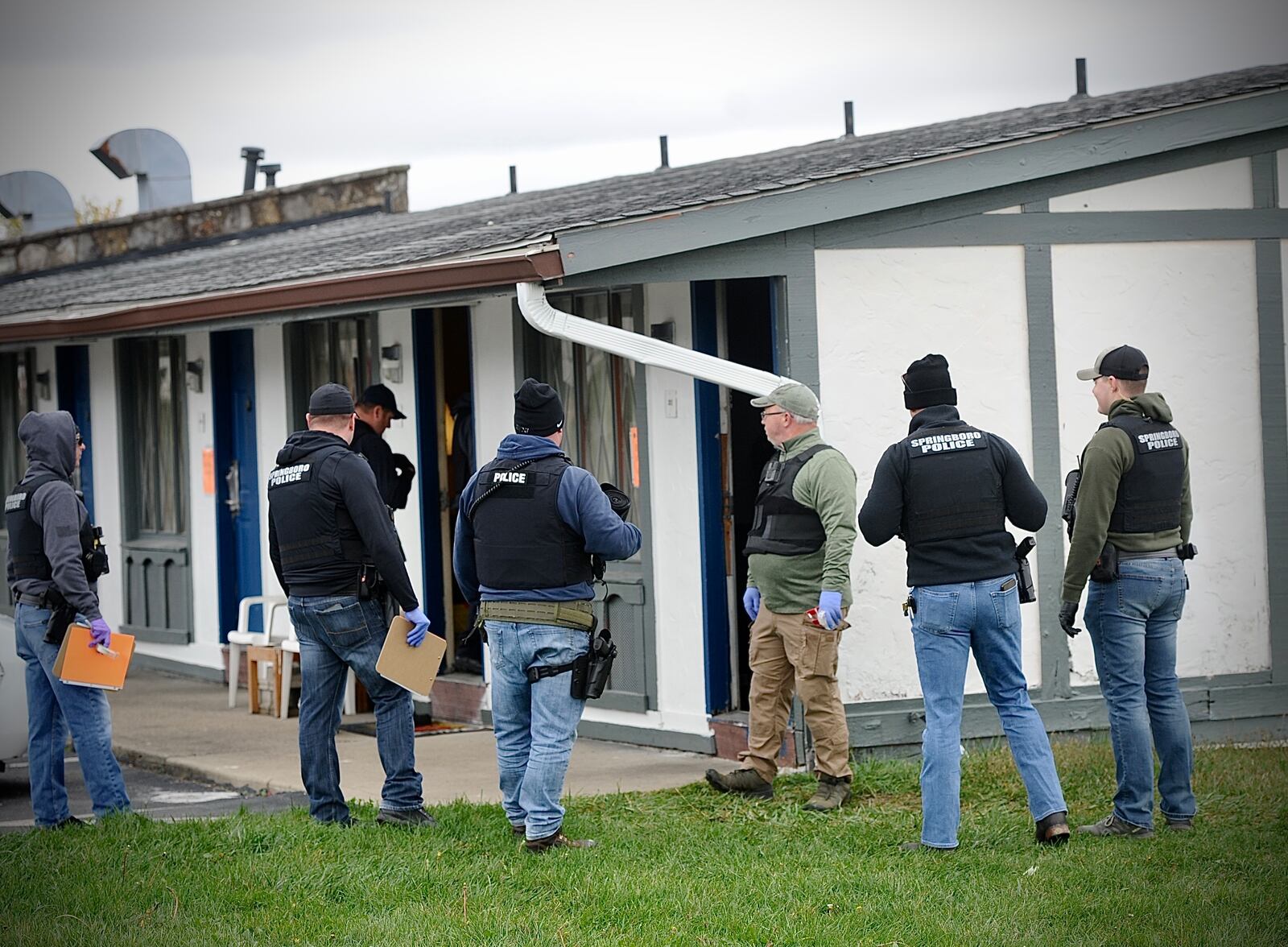 Law enforcement officers from Miamisburg and Springboro help remove guests from the Rodeway Inn, at 185 Byers Road in Miamisburg, which was being shut down Monday, Oct. 30, 2023. The city of Miamisburg called the motel “a hotbed of criminal nuisance activity" tied to drugs. MARSHALL GORBY / STAFF