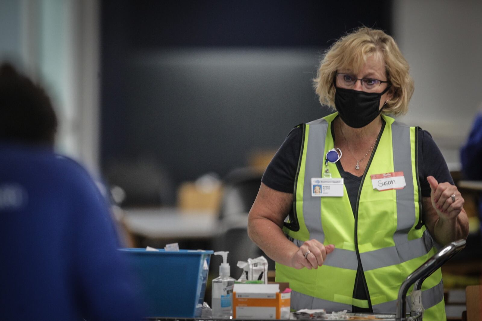 Premier Health Nurse Midwife, Susan Kloth prepares COVID-19 vaccines at the University of Dayton Arena.