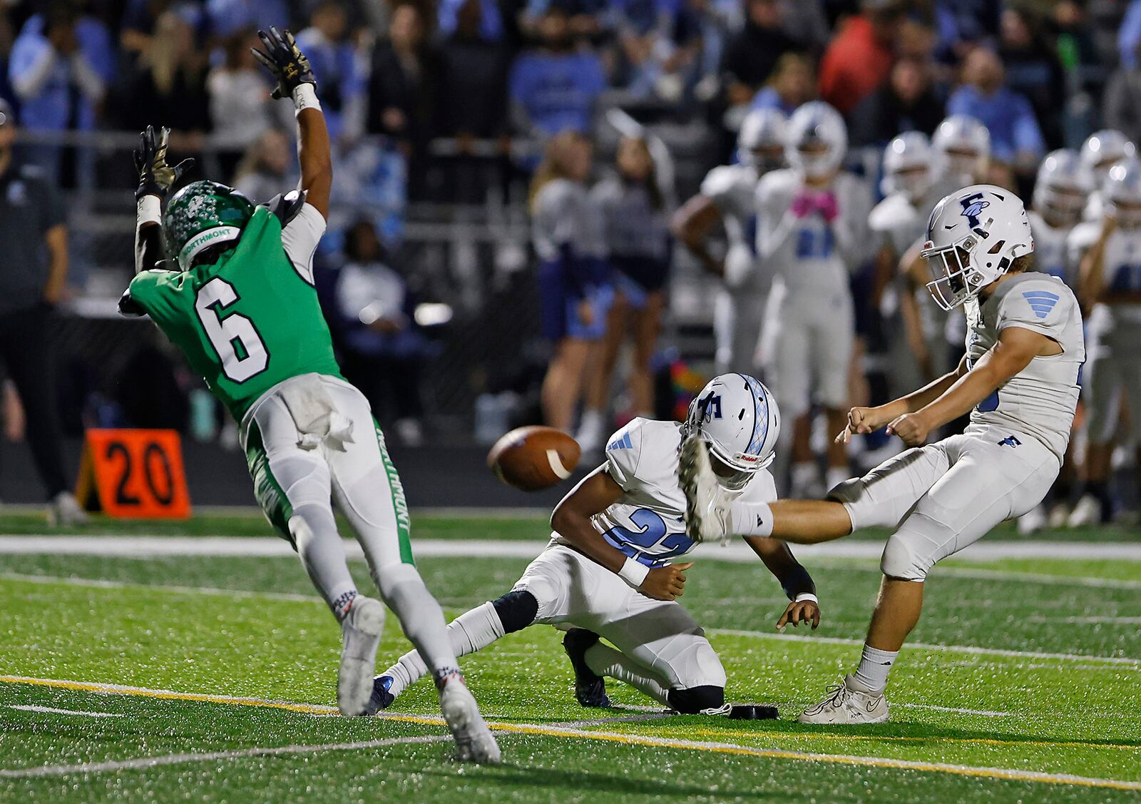 Fairborn's Wesley Rohler attempts a field goal as Northmont's Deuce Cortner goes for the block during a game Friday, Oct. 27, 2023. BILL LACKEY/STAFF