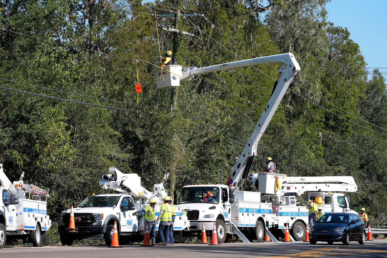 Pike Corporation linemen, of North Carolina, repair electricity damaged by Hurricane Milton Monday, Oct. 14, 2024, in Lithia, Fla. (AP Photo/Chris O'Meara)